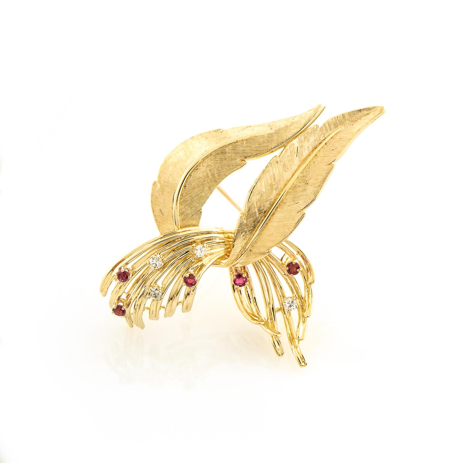 This elegant pin is crafted with a textured 14K yellow gold. The curved leaf silhouette shape is set with five round rubies weighing 0.20 carats and four round diamonds weighing 0.12 carats (G Color and S12 Clarity). 