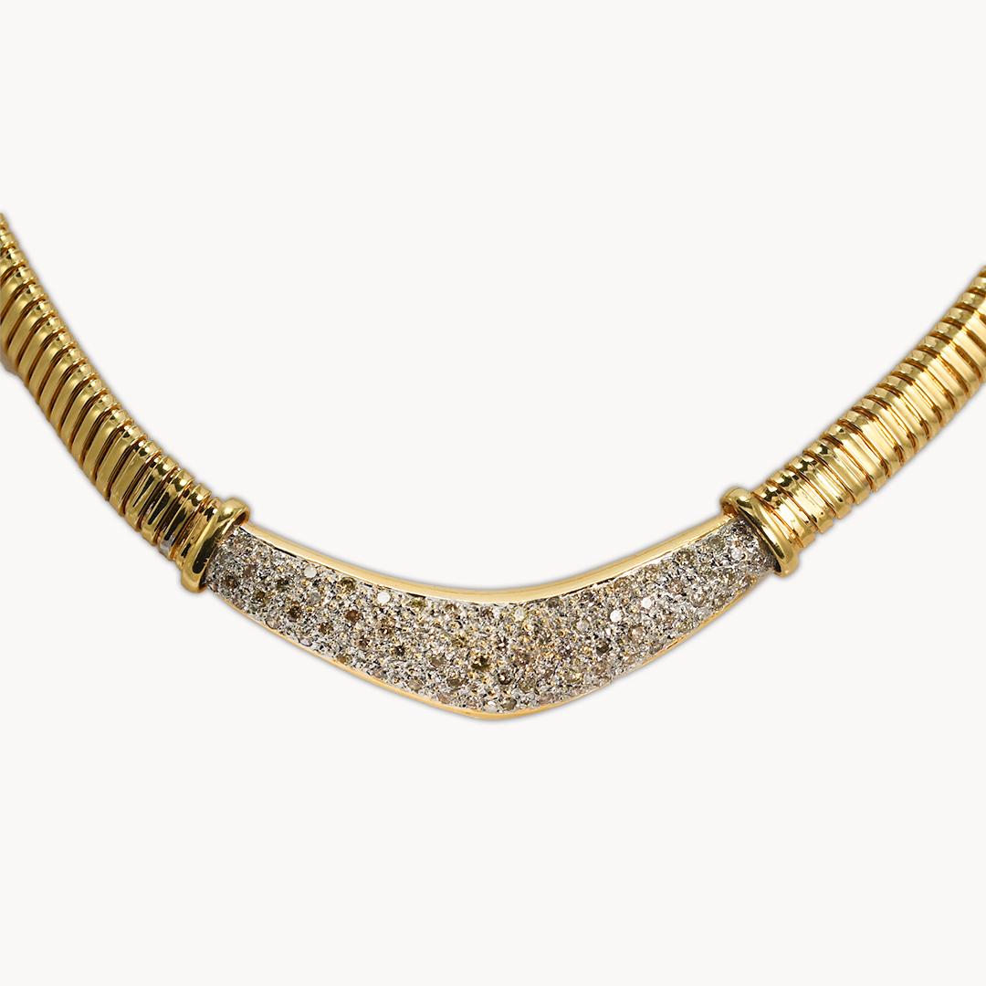 14k yellow gold, flex link diamond necklace.
Stamped 14k Italy and weighs 33 grams.
The diamonds are round brilliant cuts, 2.00 total carats, pave set, champagne color, Si to i1 clarity.
One diamond is cracked.
It can only be seen under