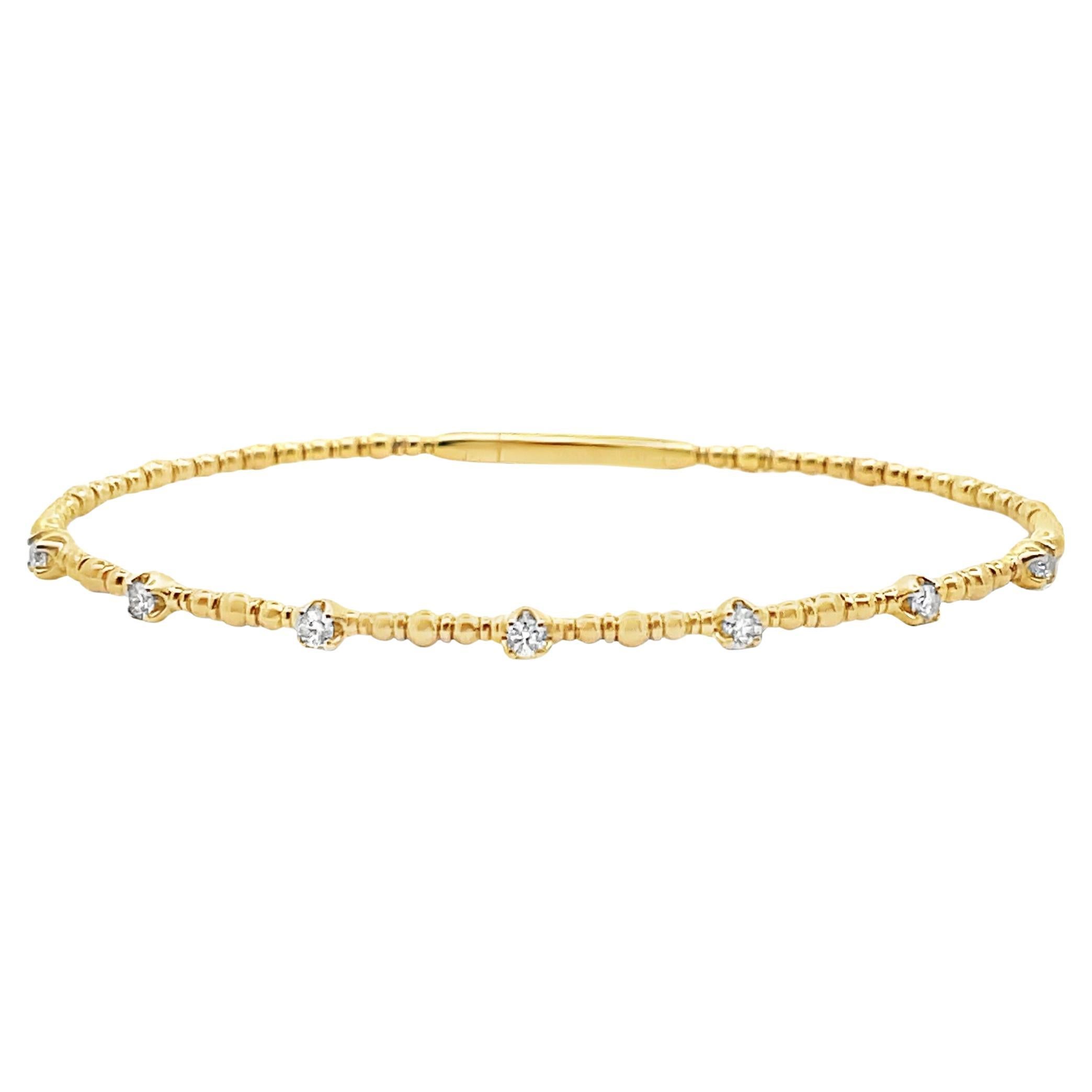 Armreif aus 14 Karat Gelbgold mit flexiblen Diamanten