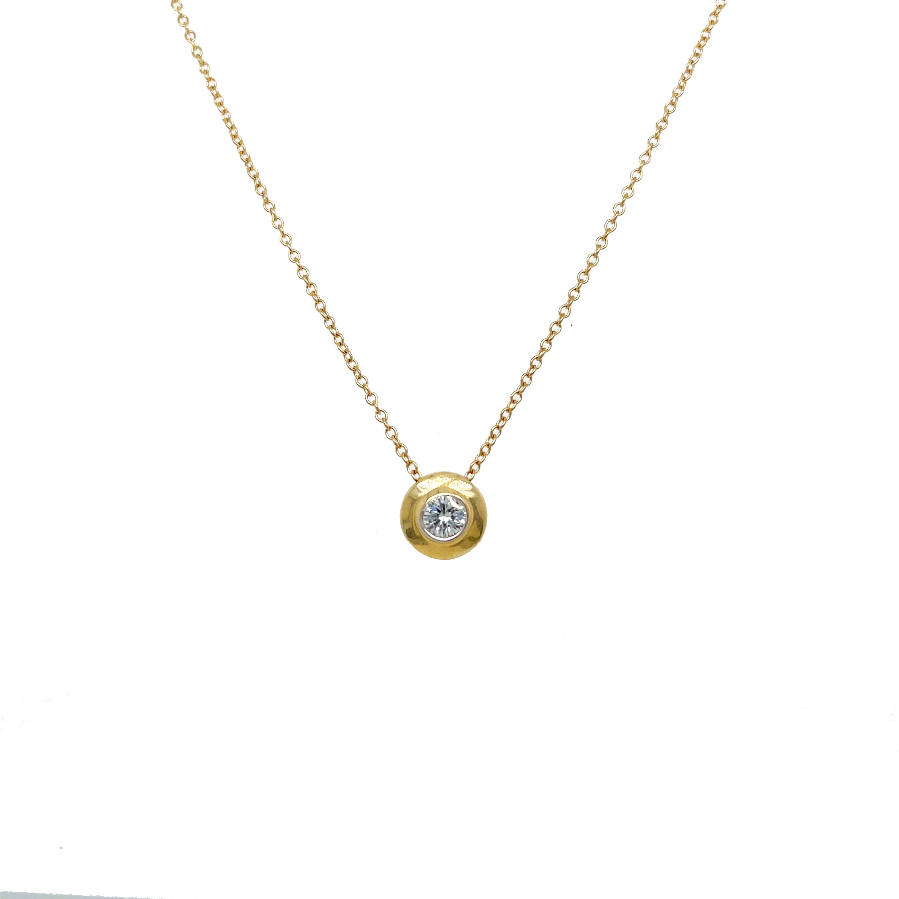 This is a lovely floating diamond set bezel necklace set in 14K yellow gold! This stunning necklace showcases a sparkling round diamond bezel set in bright yellow gold that would pair well with any outfit for any occasion! This necklace is the