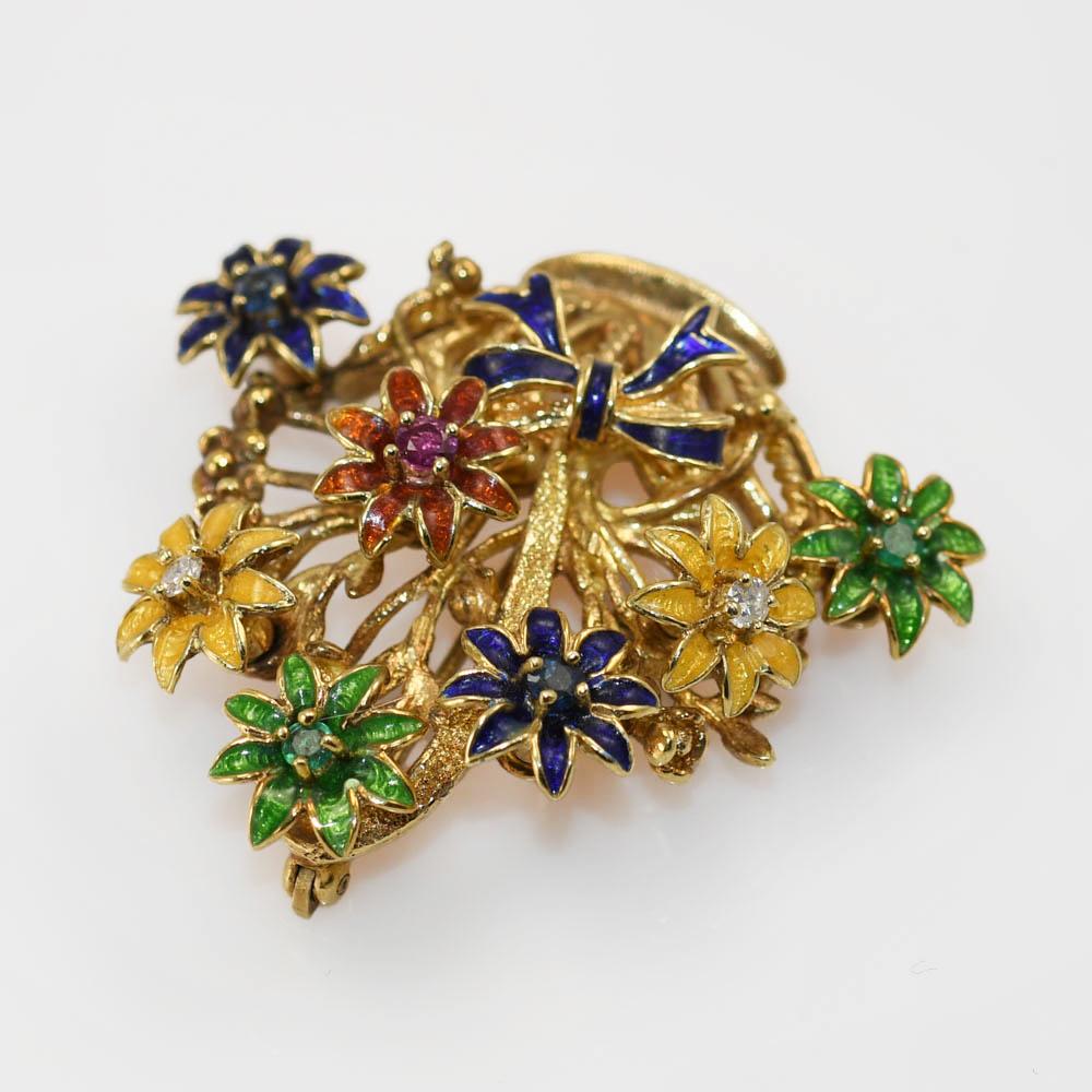 The brooch is shaped as a flower basket,

with flowers that spin with different gemstones in the center.

Diamond, Ruby, Sapphire, and Emerald. 

Weighs 17.2gr, tests 14k. 

40mm long, 35mm wide 

