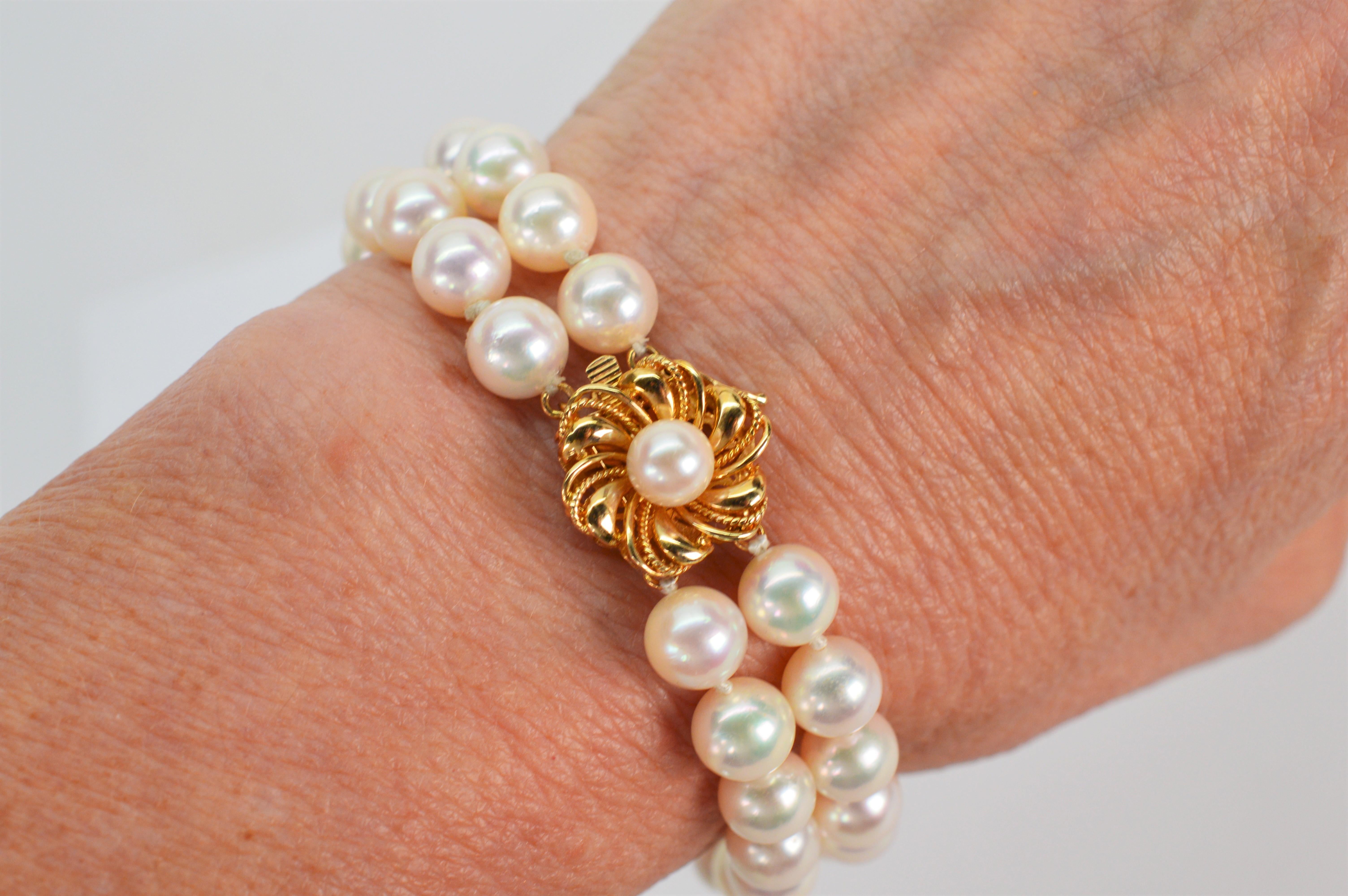 A gorgeous pearl bracelet that transcends classic style.  Featuring an adorable 14 karat yellow gold floral inspired decorative clasp with one lustrous 6mm round AAA Akoya Pearl nested in the gold petals which also functions as a fine box clasp.