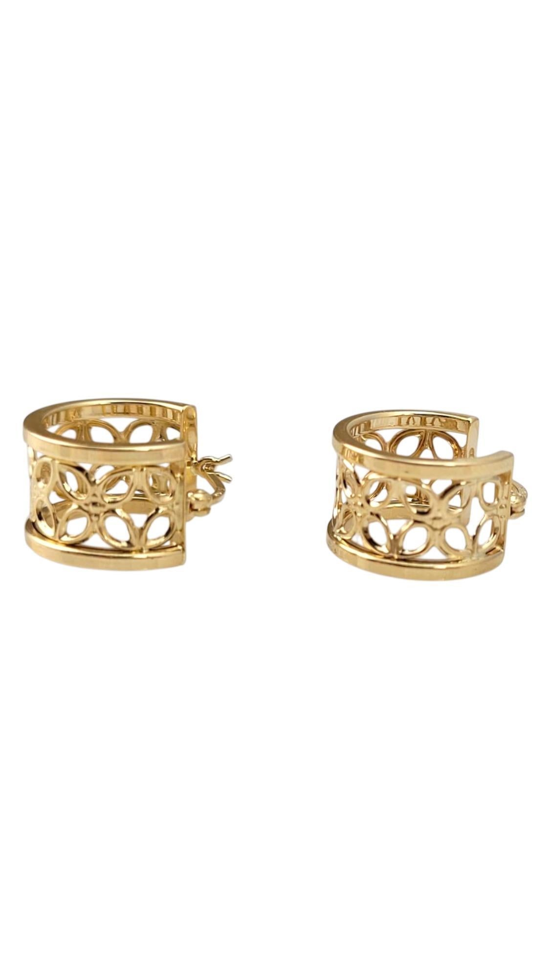14K Yellow Gold Flower Band Hoop Earrings -

These 14K yellow gold flower band earrings feature a delicate floral motif, beautifully crafted to highlight nature-inspired elegance. With their polished finish and intricate detailing, they add a touch