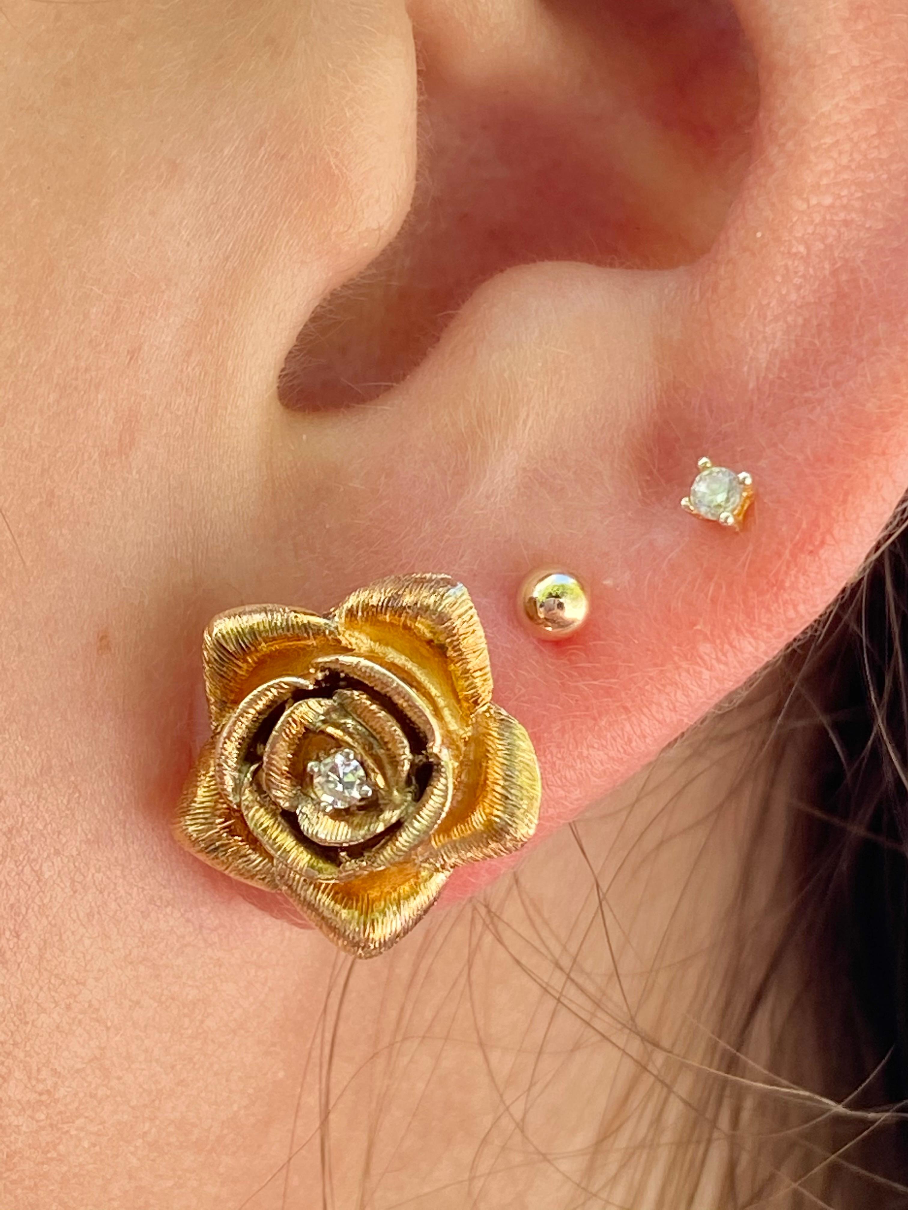 Cute and dainty 14k solid gold flower design with a natural diamond set in the center. These earrings are set in 14k gold push back closure and a brushed, texture gold finish.

Hypoallergenic and double rhodium plated for an extra shiny