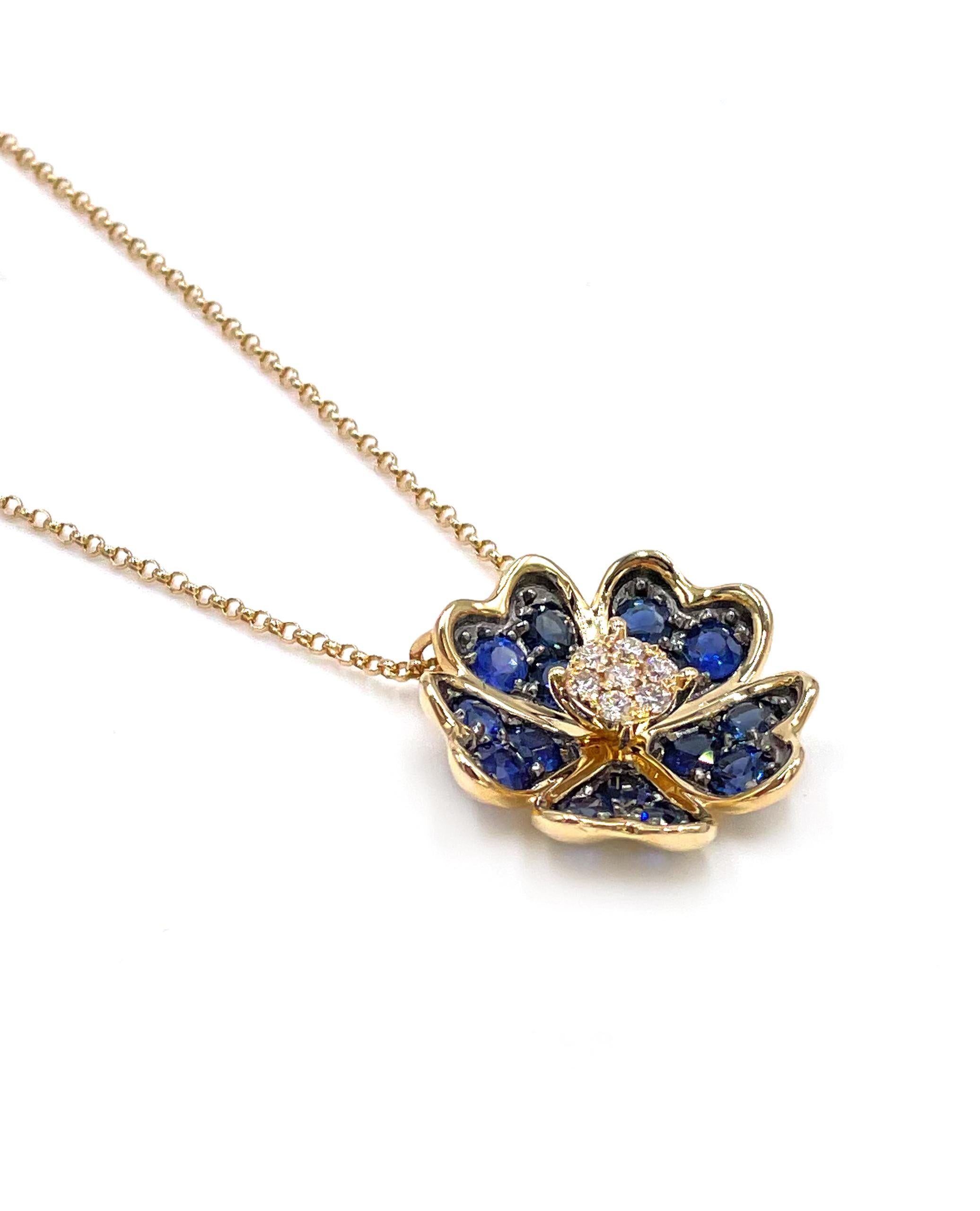 14K yellow gold flower pendant necklace furnished with round faceted diamonds weighing  0.11 carats total weight and round faceted blue sapphires weighing 1.20 carats total weight.

* Can be worn 16, 17 or 18 inches long.