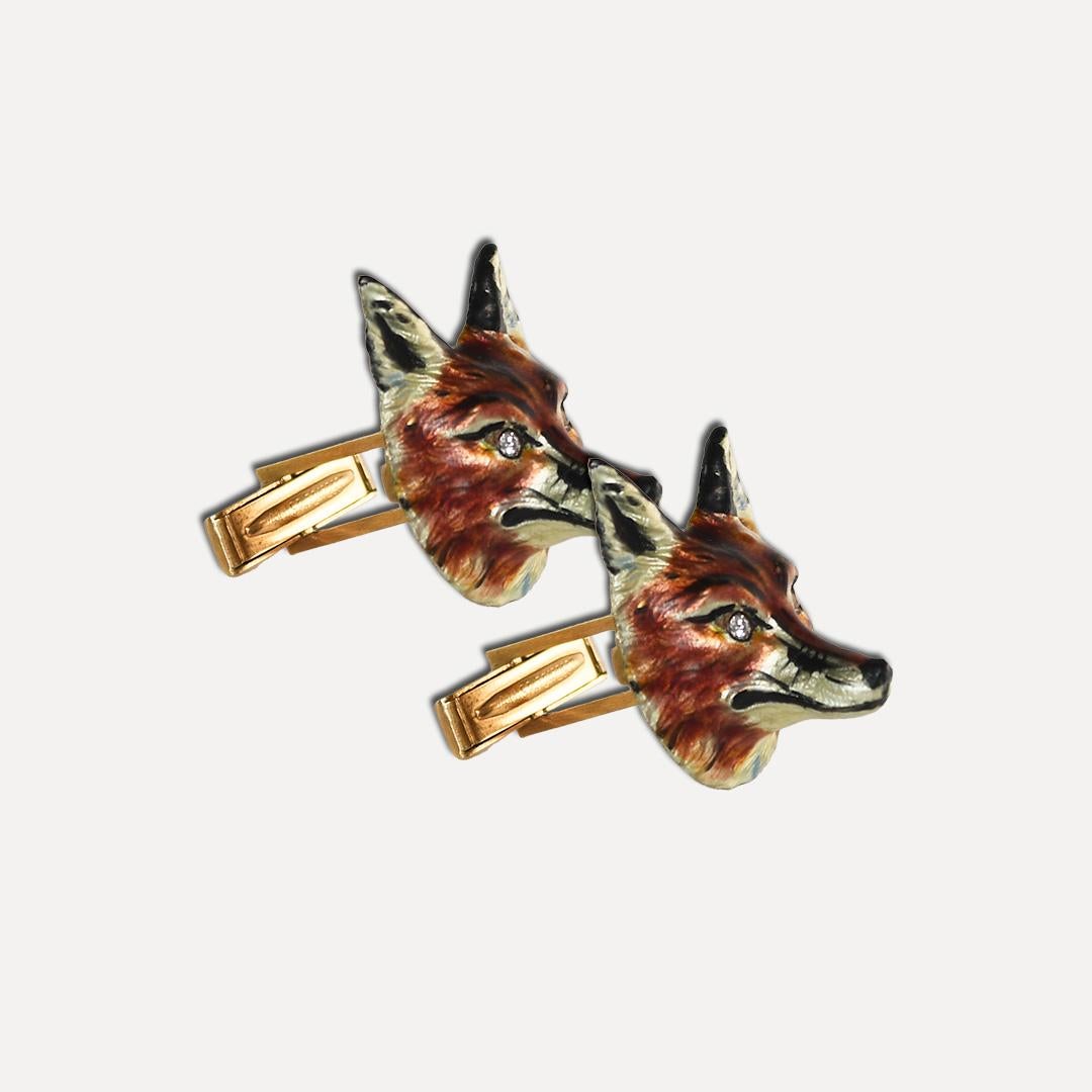 Fox figurine cufflinks with 14k yellow gold settings.
Stamped 14k and weighs 27 grams.
The cufflinks have a baked-on color coating on the fox heads.
There are round brilliant diamonds in the fox eyes, .12 total carats, good quality.
The fox heads