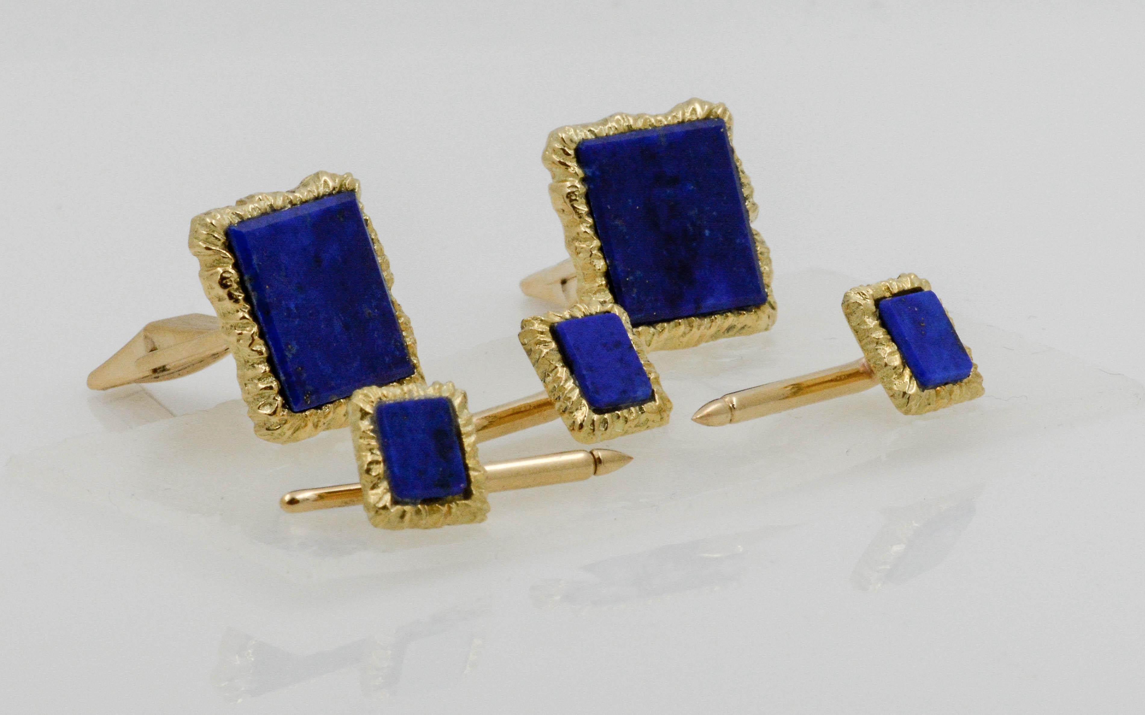 This polished look gives his business attire a classic finish. Made in 14K textured yellow gold, each of these refined men's rectangular cuff links and shirt studs feature a rich  Lapis Lazuli gemstones in a square frame. Buffed to a bright luster,