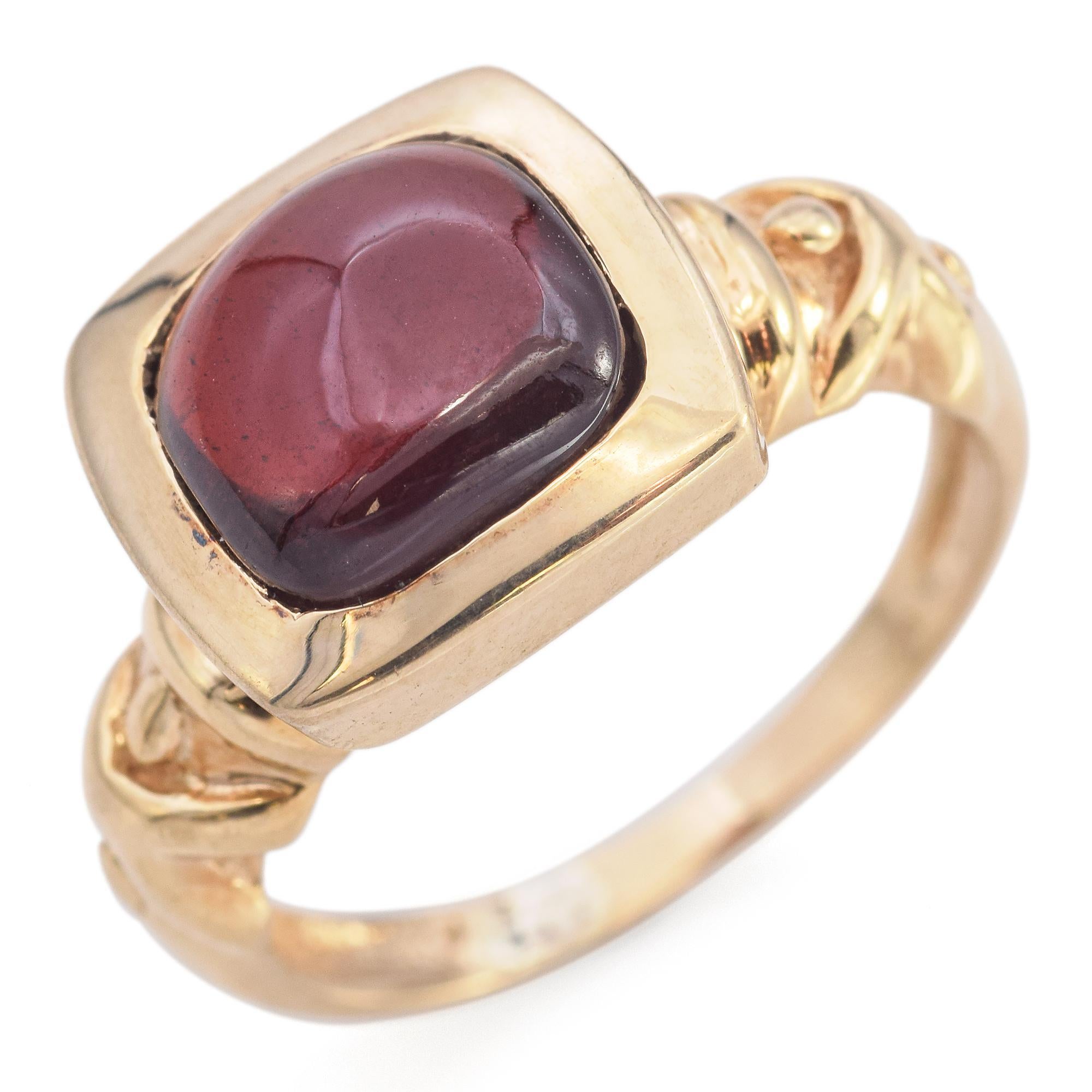 Step into the allure of the 20th century with our exquisite Garnet Cabochon Ring, a testament to timeless elegance. Crafted in 14K yellow gold, this piece features a captivating 2.7-carat red garnet, cut in a smooth cabochon style that enhances its