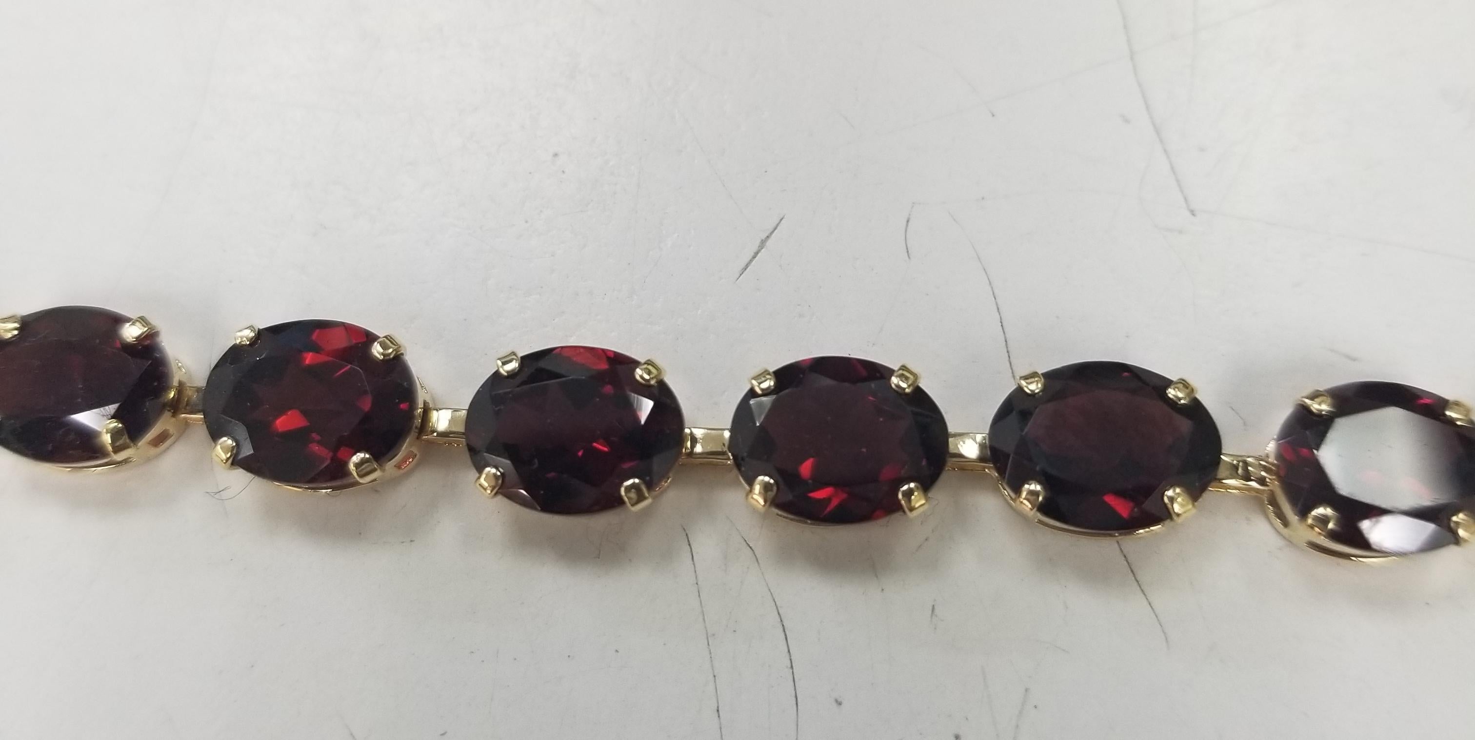 Oval Cut 14k Yellow Gold Garnet Prong Bracelet with Approx. 30cts. For Sale
