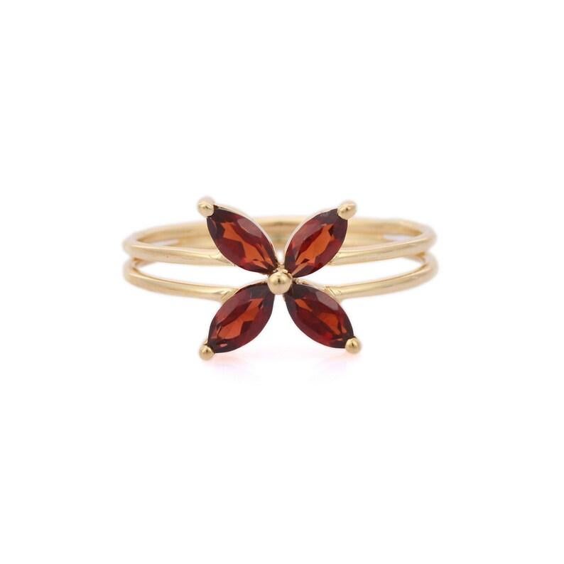 Dainty Garnet Flower Ring in 14K Gold featuring natural garnet of 0.7.3 carats. The gorgeous handcrafted ring goes with every style.
Garnet purifies and balances energy.
Designed with four marquise cut red garnet making a flower in center set in