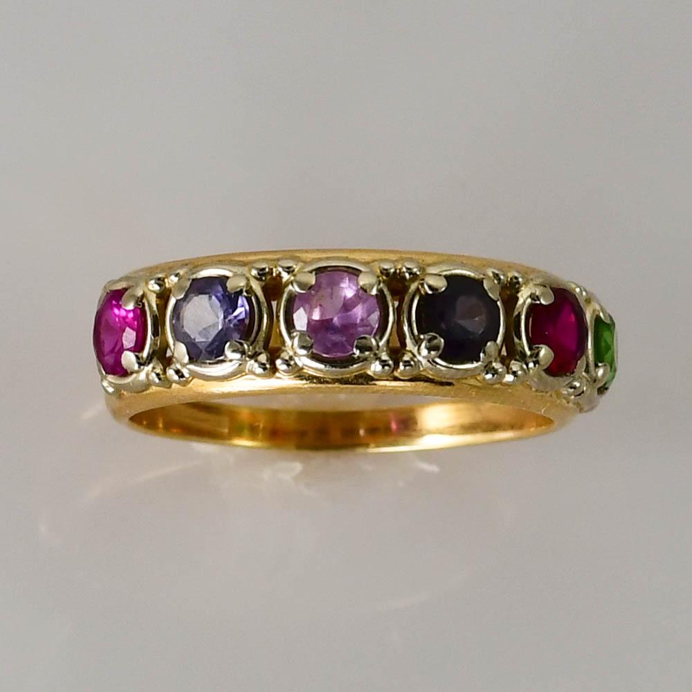 One 14K yellow gold stone ring. 
There are 6 stones all different colors, all synthetic, all 3.5mm each.
This ring was made with 2 separate gold bands.
They are each 2mm, and stamped GB-14K on the inside. 
 This ring is a size 8.5 and weighs 5.0