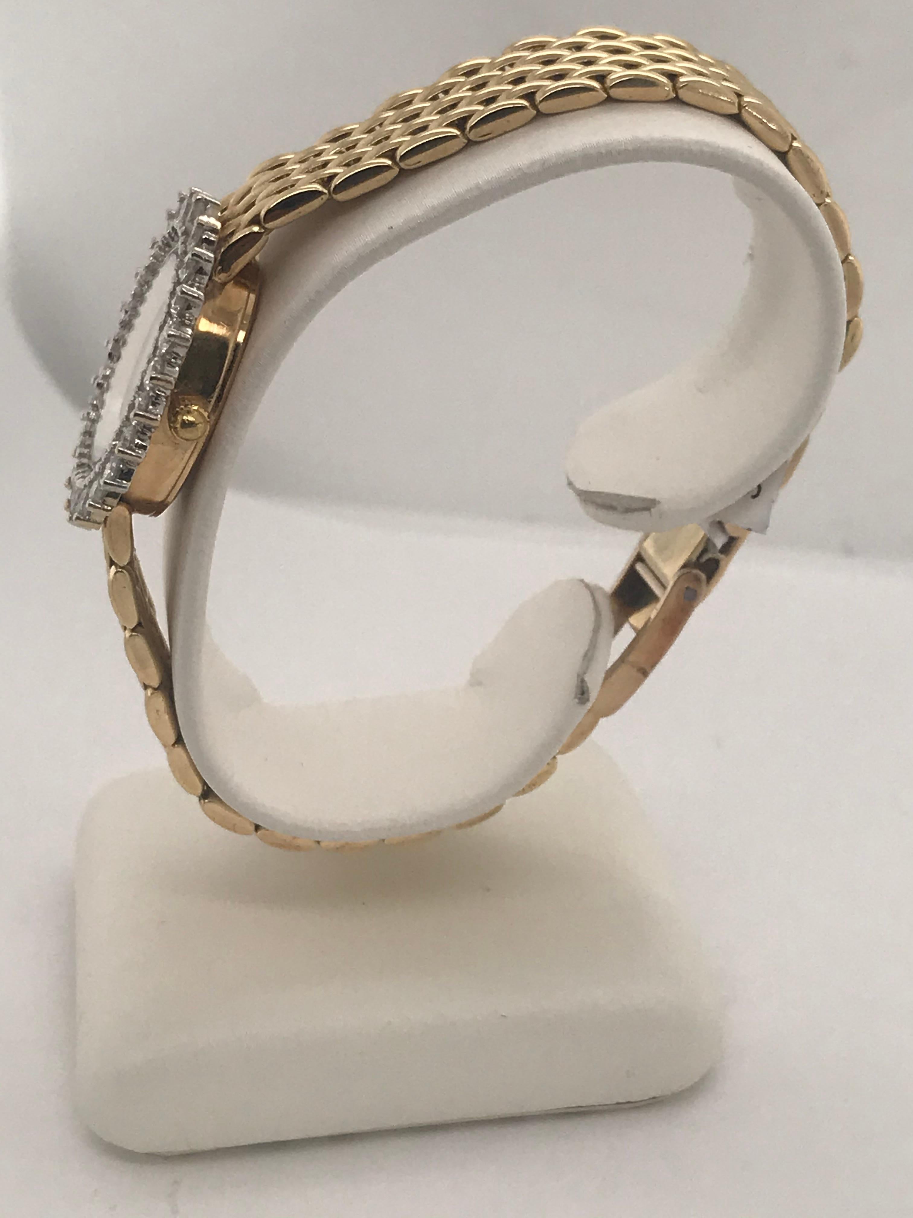 This 14K yellow gold 7 row rounded brick pattern Geneve watch has 24 brilliant cut diamonds totaling approximately 2.00ct total weight.  It's beautiful mother of pearl dial makes it an easy read for any time of the day.  This watch also has an easy