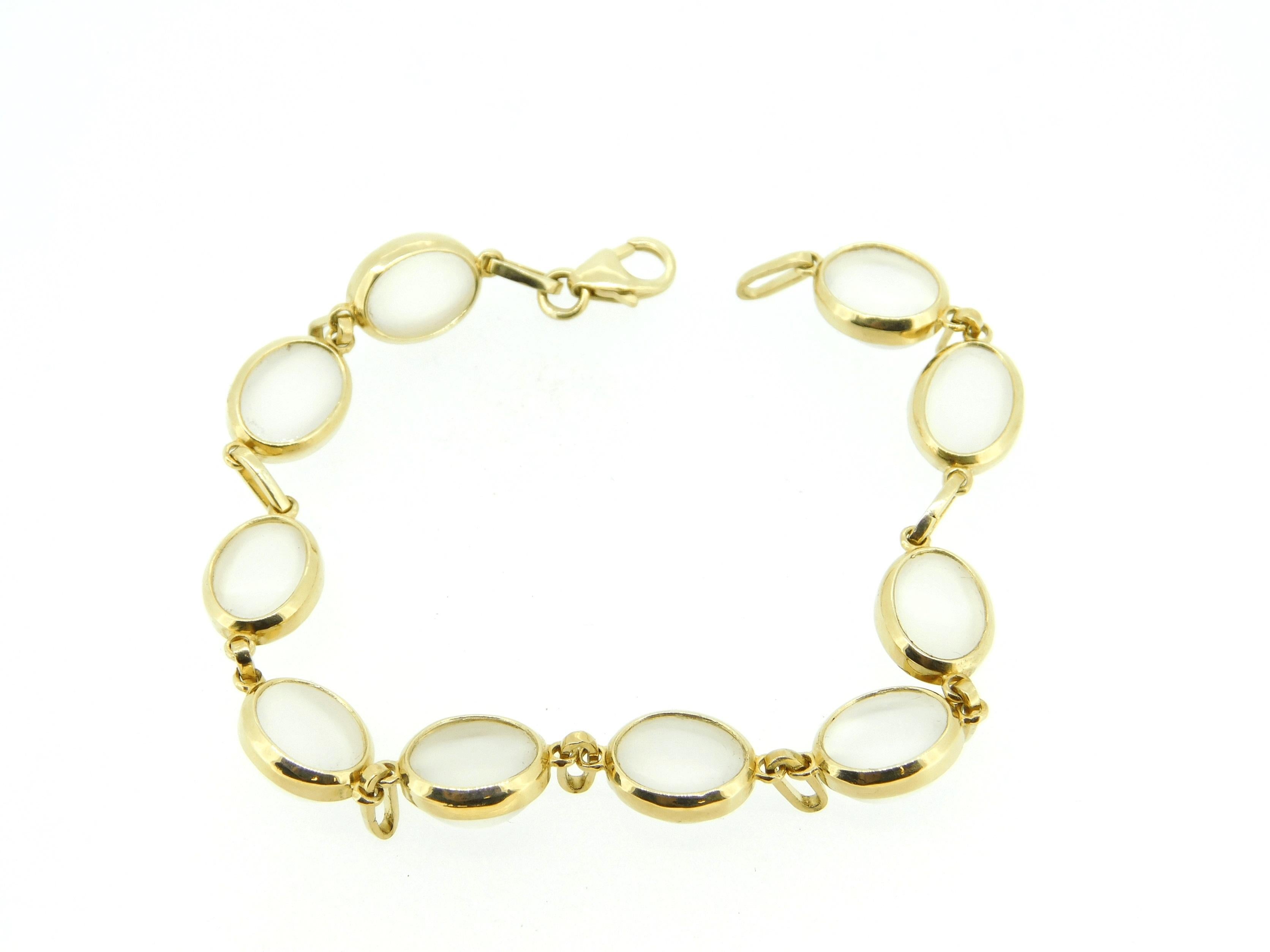 14k Yellow Gold Genuine Natural 23.59ct Moonstone Bracelet (#J4341)

14k yellow gold custom moonstone bracelet. There are ten oval moonstones weighing 23.59 carats total. The moonstones are set in oval bezels with a custom link. The moonstones