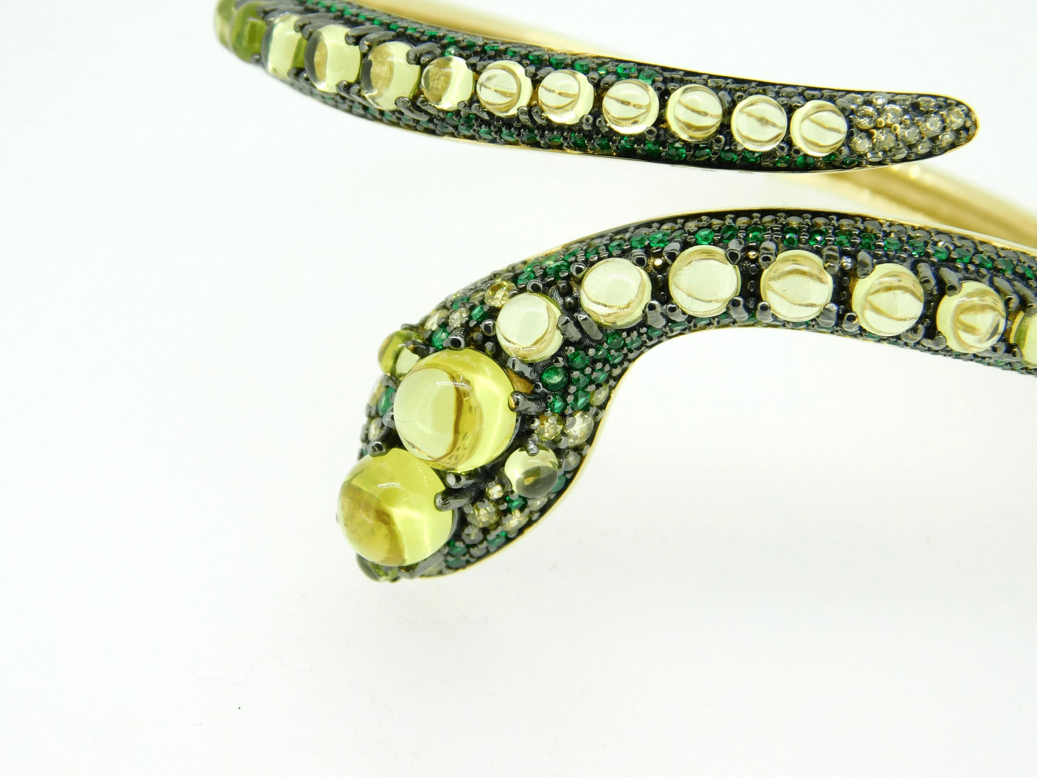 14k Yellow Gold Genuine Natural Peridot Snake Bangle Bracelet (#J4469)
14k yellow gold snake bangle bracelet with cabochon peridot gemstones accented with multi-color green paste/glass stones. It is large, measuring 3