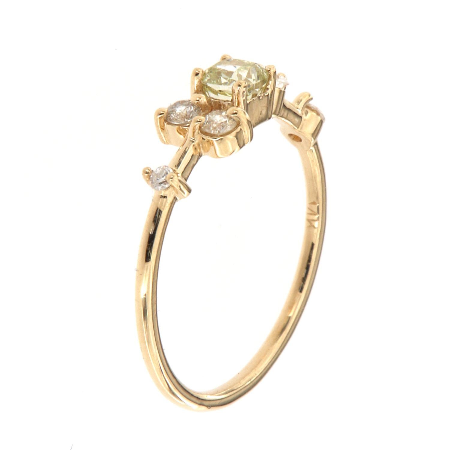 This 14K yellow gold petite ring features five (5) round brilliant diamonds scattered on a delicate 1.2 mm band. A perfectly square GIA-certified 0.31 Carat Cushion shape Yellow diamond is placed in the center of this organically designed ring