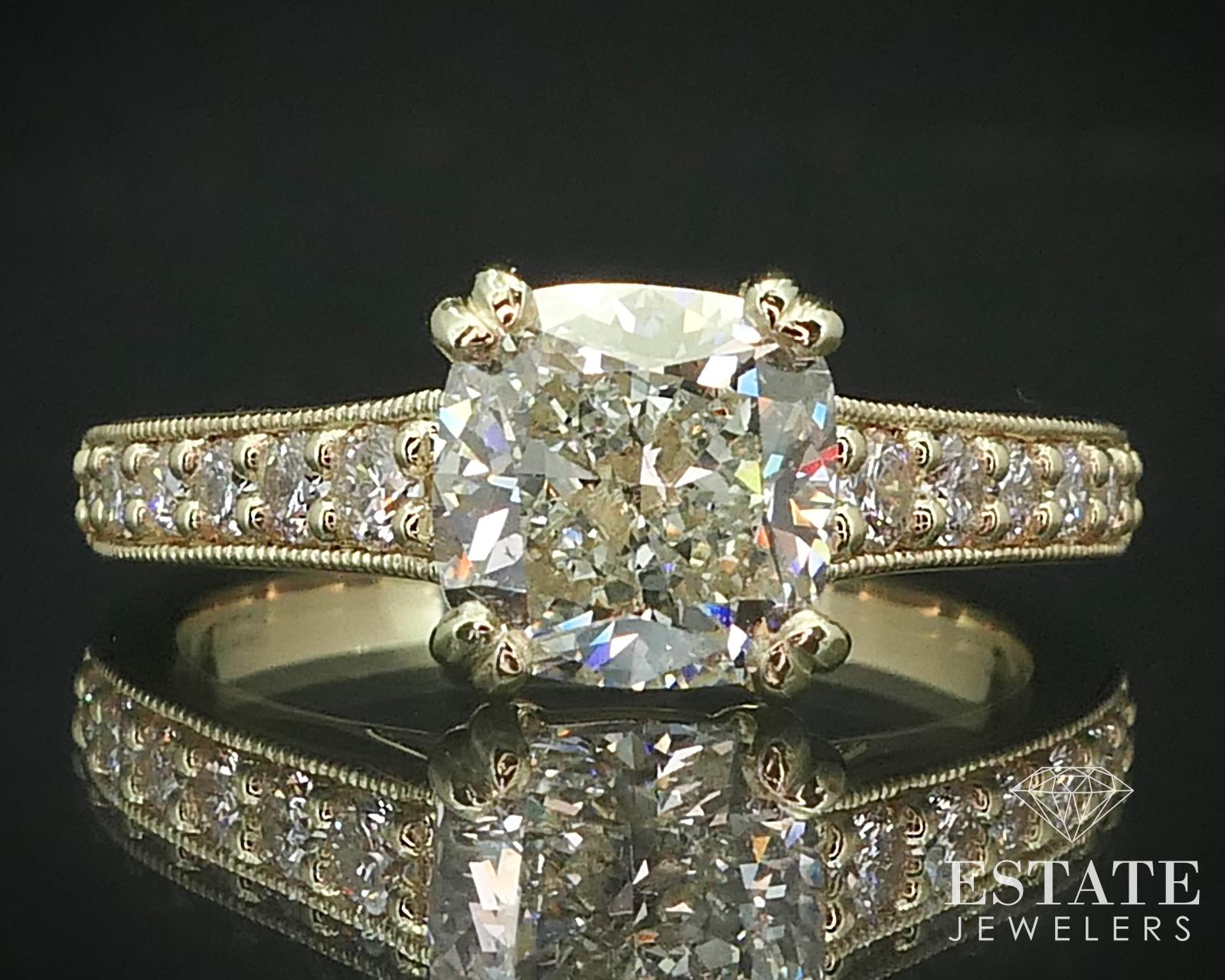 Sparkling yellow gold engagement ring with a newly mounted 2.18ct GIA certified cushion cut main diamond. SI1 clarity with J color to it. Approximately .30ctw of accent diamonds. Stamped 14k SIZE-6.5. GIA number 1285610212