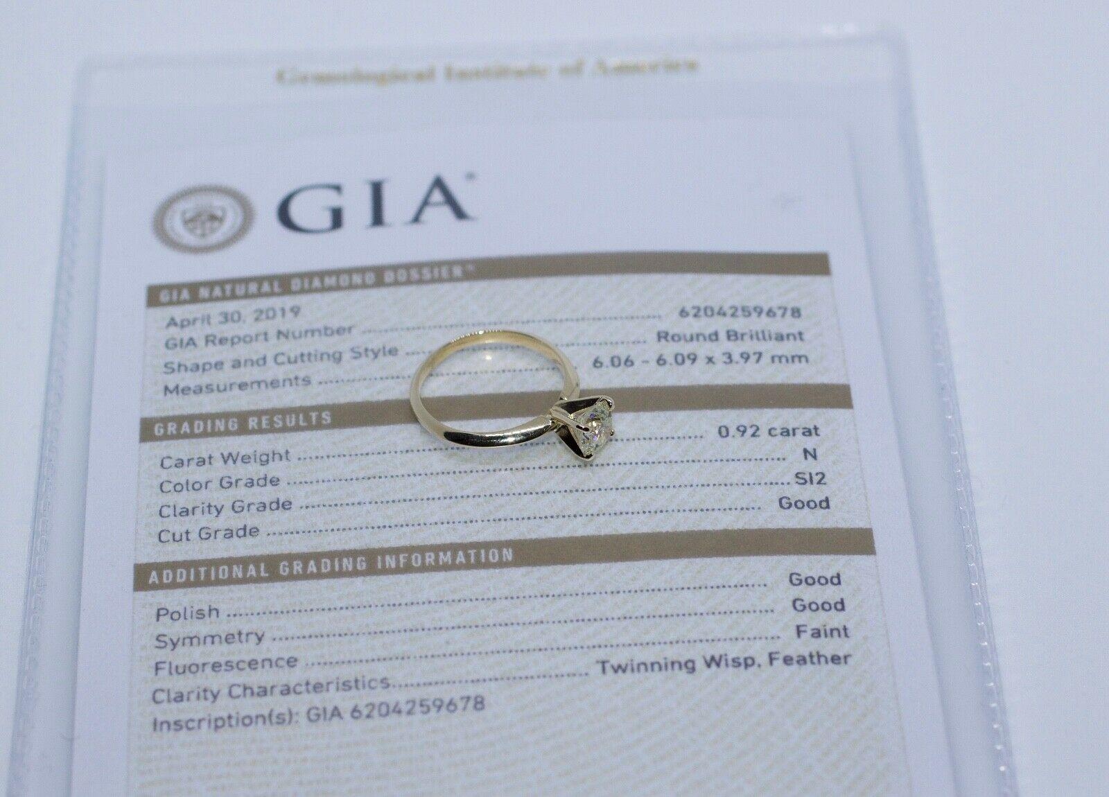 14k Yellow Gold Round GIA Certified Diamond Solitaire Engagement Ring
Ring Size 5.75
2.0 Grams
1 Round Brilliant Cut Diamond 0.92 Carats 
Color: N Clarity: Si2