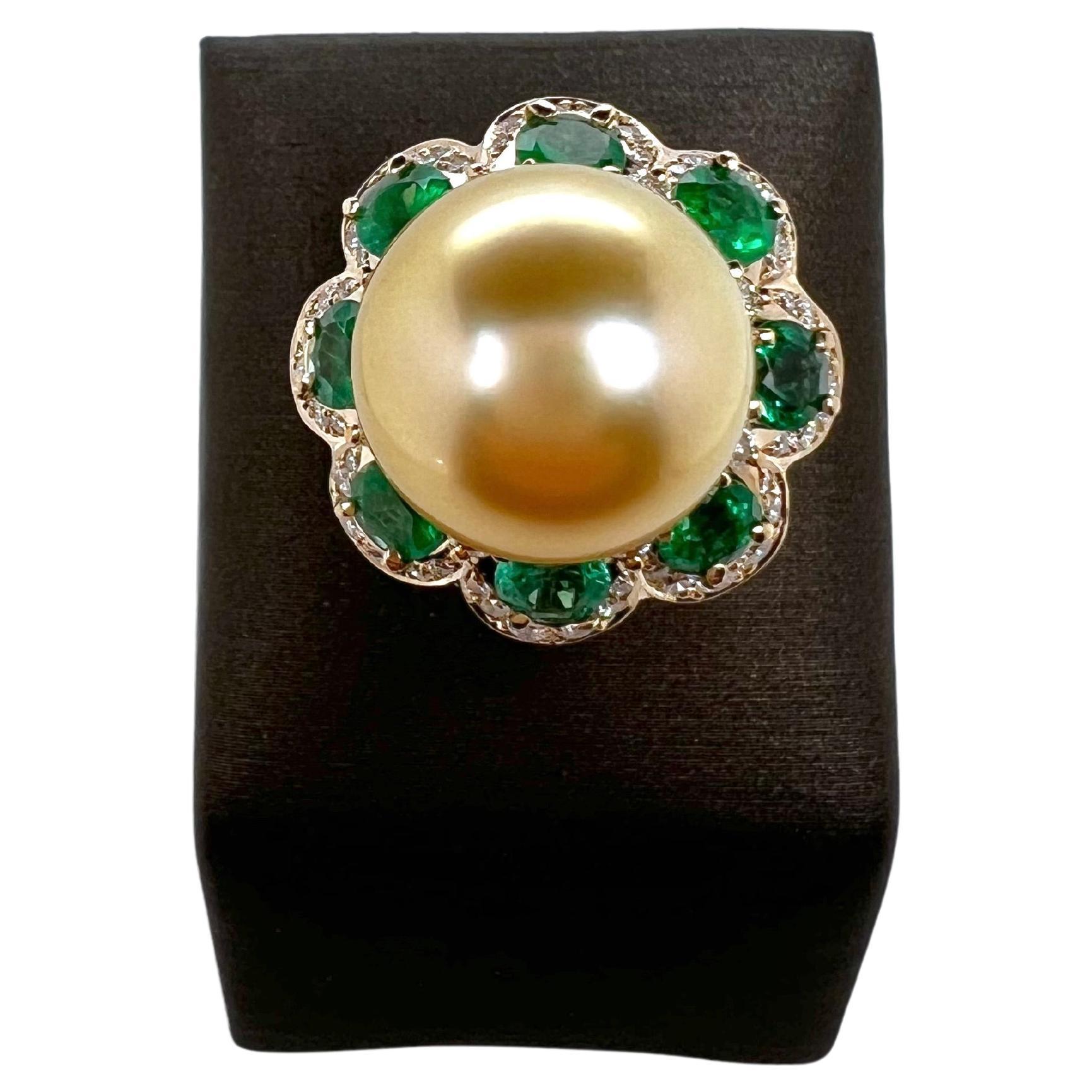 Absolutely regal!  This gorgeous golden south sea pearl has an amazing luster and is set in a handmade, emerald and
diamond ballerina-like setting in 14k yellow gold.  The round emeralds are evenly spaced out amongst the round
diamonds.  The 14mm