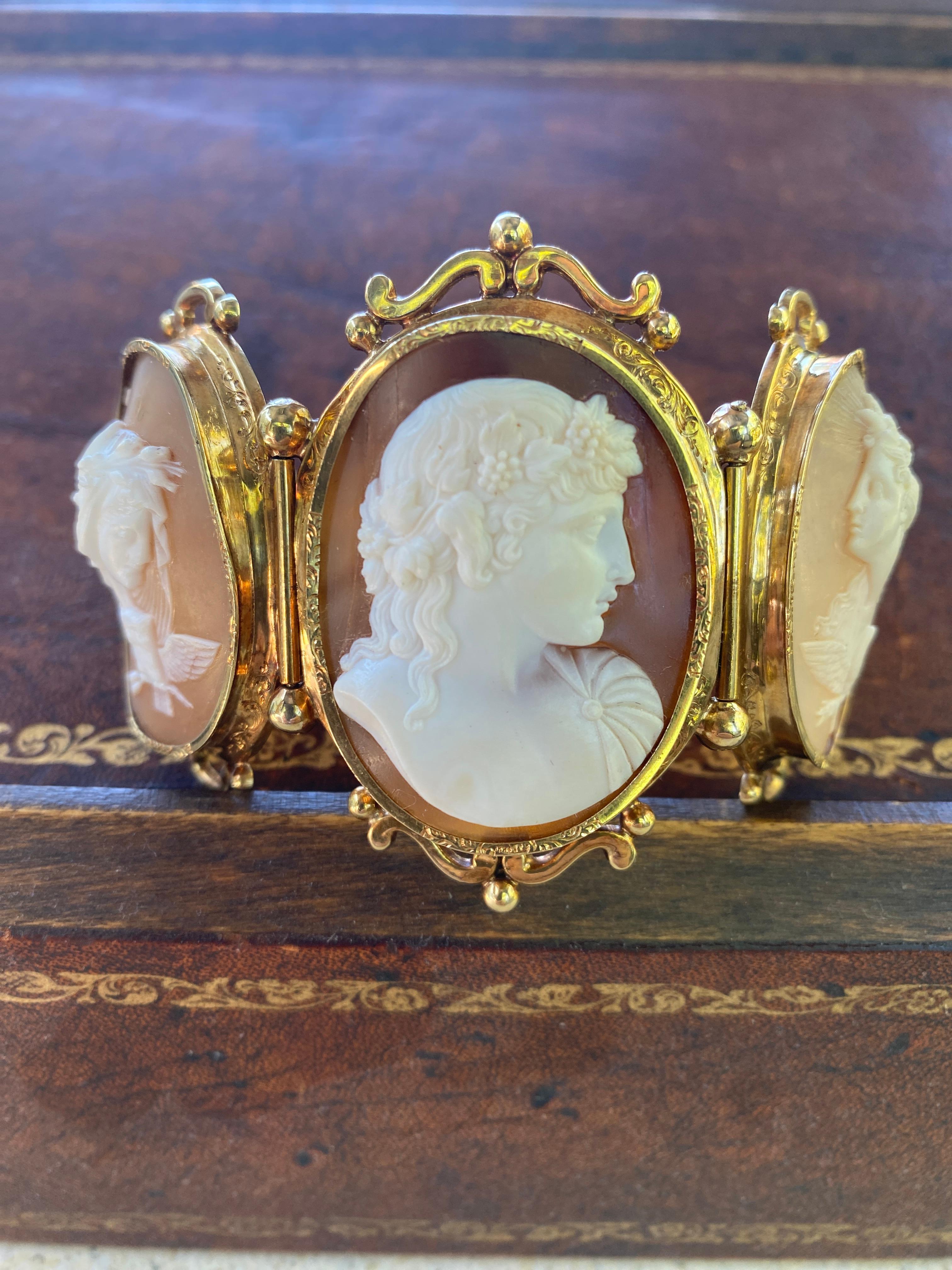Fantastic Antique circa late 1900's, 14K gold bracelet set with three large finely hand carved shell cameos.  At the center is a finely carved Greek God, Bacchus beautifully detailed with his hair tendrils intertwined with grapes and grape leaves. 