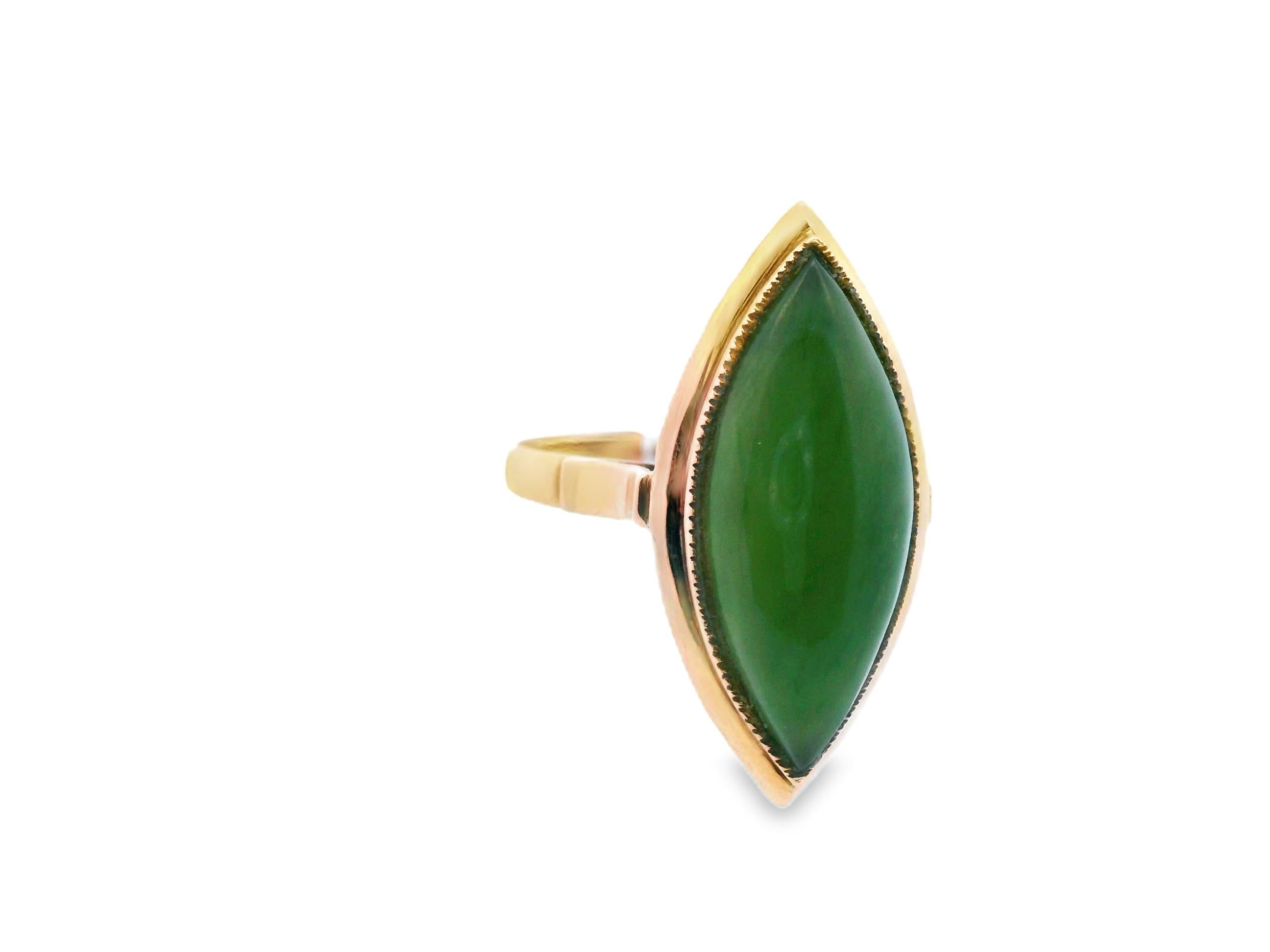This beautiful 14k yellow gold ring features an exquisite cabochon nephrite jade. The under gallery is constructed with enchanting filigree that allows light to come through the jade, causing it to practically glow. The jade is 21mmx9mm, making this