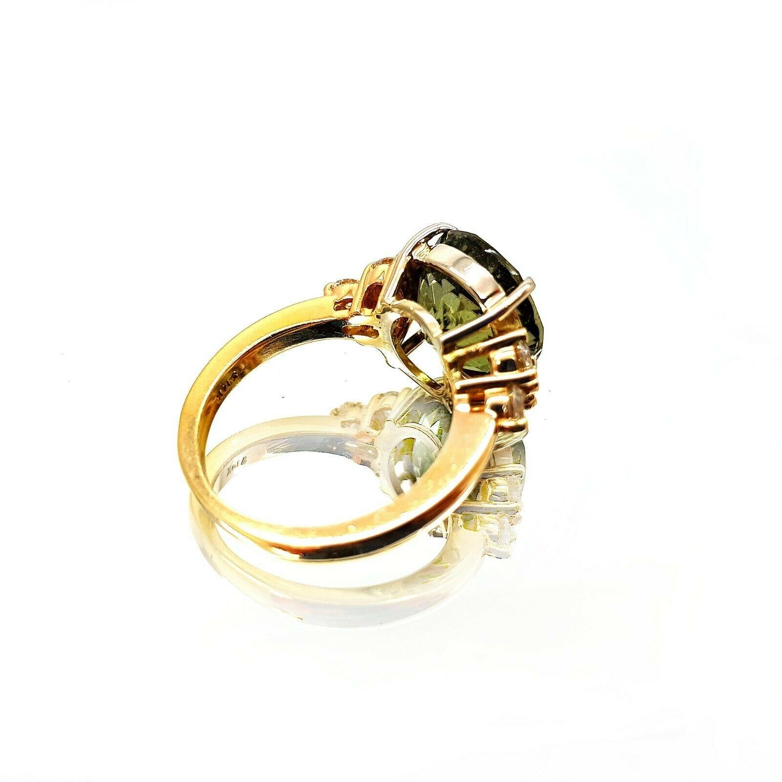  This is an 14k Yellow gold Tourmaline diamond ring. The main stone has the beautiful color of Green and is approximately 7.00 carat weight. It has a 6pcs round diamonds and has an approximately 0.60 carat total weight, H color and VS2 clarity. Its