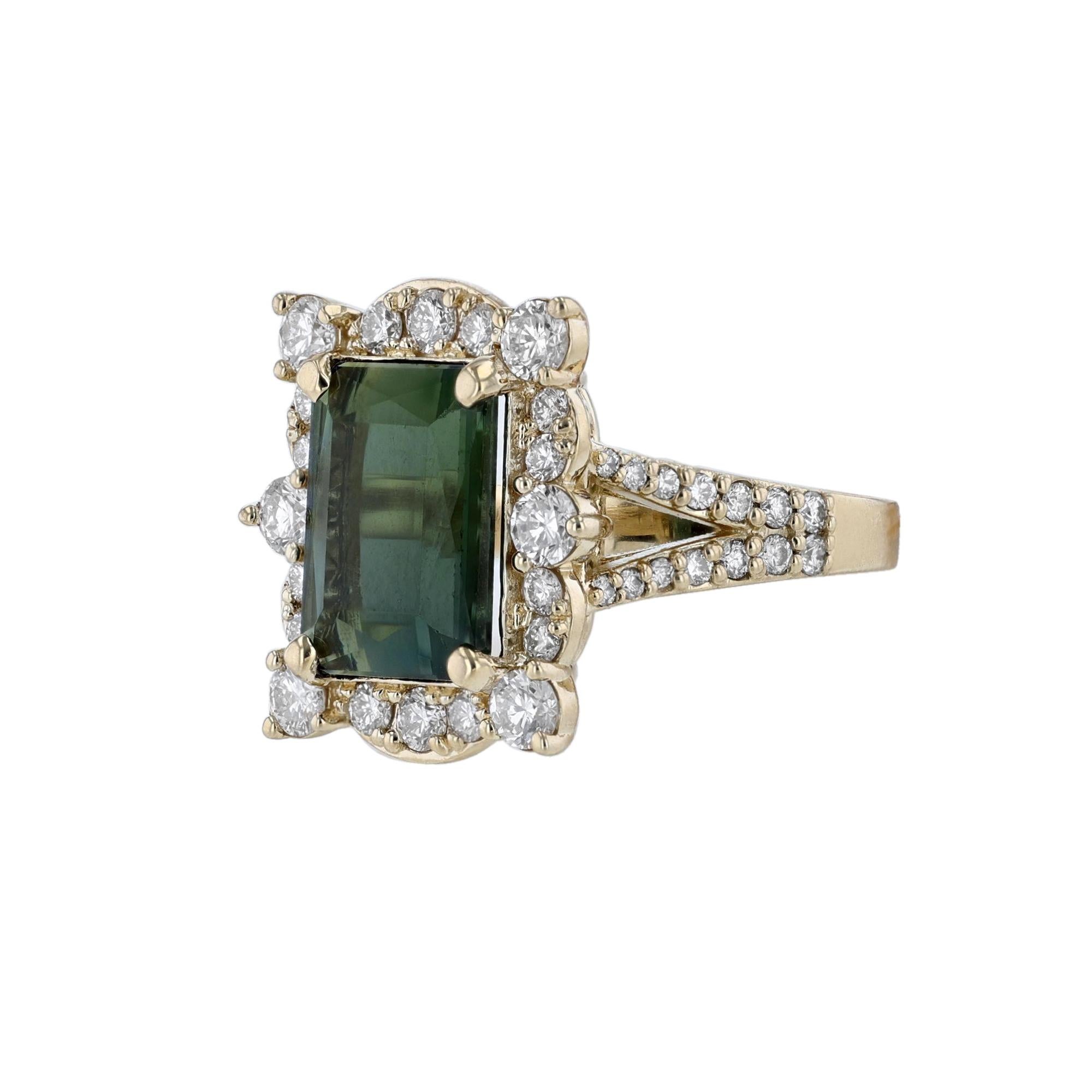 This ring is in 14K yellow gold. It features 1 emerald cut Green Tourmaline weighing 5.95 carats. Along with 48 round cut diamonds weighing 1.50 carats. All stones are prong set. With a color grade (H) and clarity grade (SI2). 
