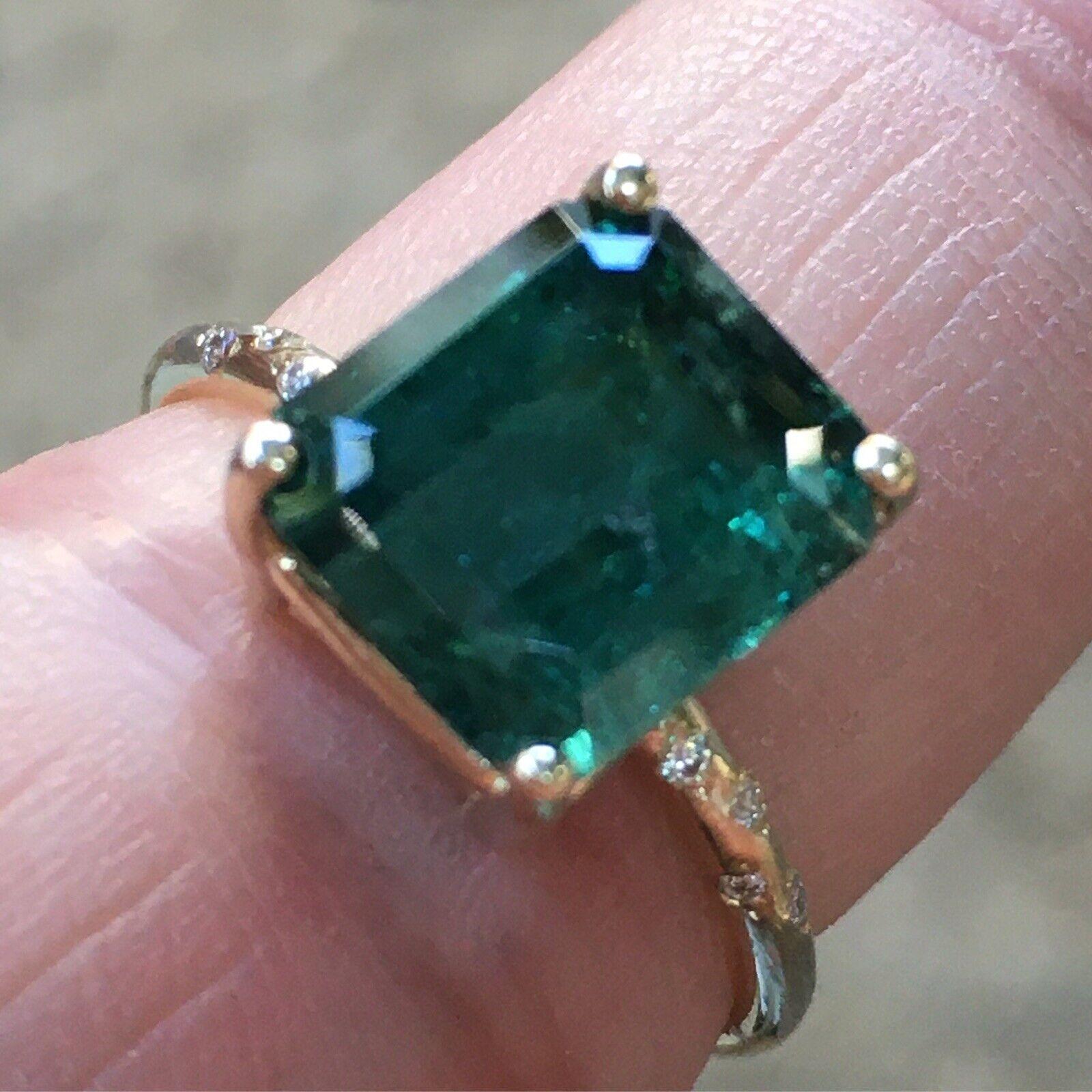 14K Yellow Gold GreenTourmaline Diamond Ring Size 7

4.40Ct Green Tourmaline measuring 10mm by 8.8mm
Ring size 7 weighting 2.8 gram
8 pieces of 1mm diamonds weighting total of .04 Carat in Zigzag Pave style setting
Made in USA 