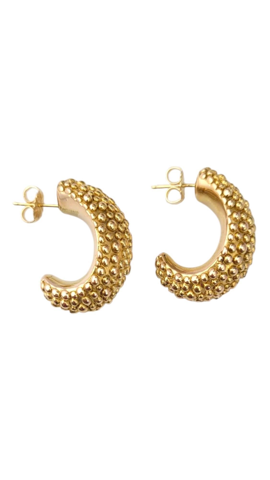 14K Yellow Gold Half Oval Dot Hoop Earrings -

These 14k yellow gold hoop earrings exude timeless elegance with their sleek and smooth finish. The perfect size for everyday wear, they offer versatility and style, effortlessly complementing any