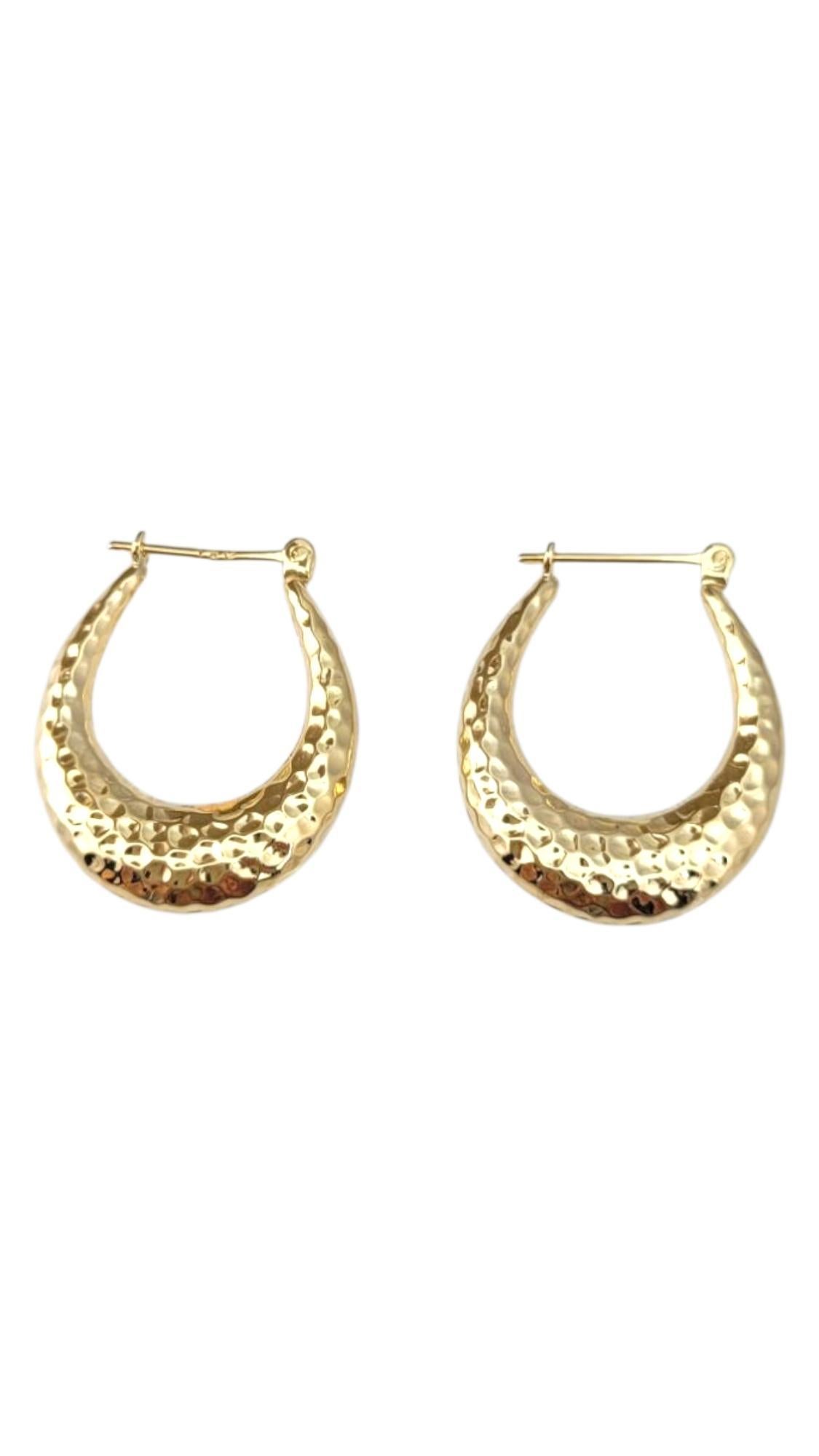 14K Yellow Gold Hammered Hoop Earrings -

These hammered hoop earrings feature a textured finish that catches the light beautifully, adding depth and dimension to a classic silhouette. Their artisanal look offers a modern twist on timeless