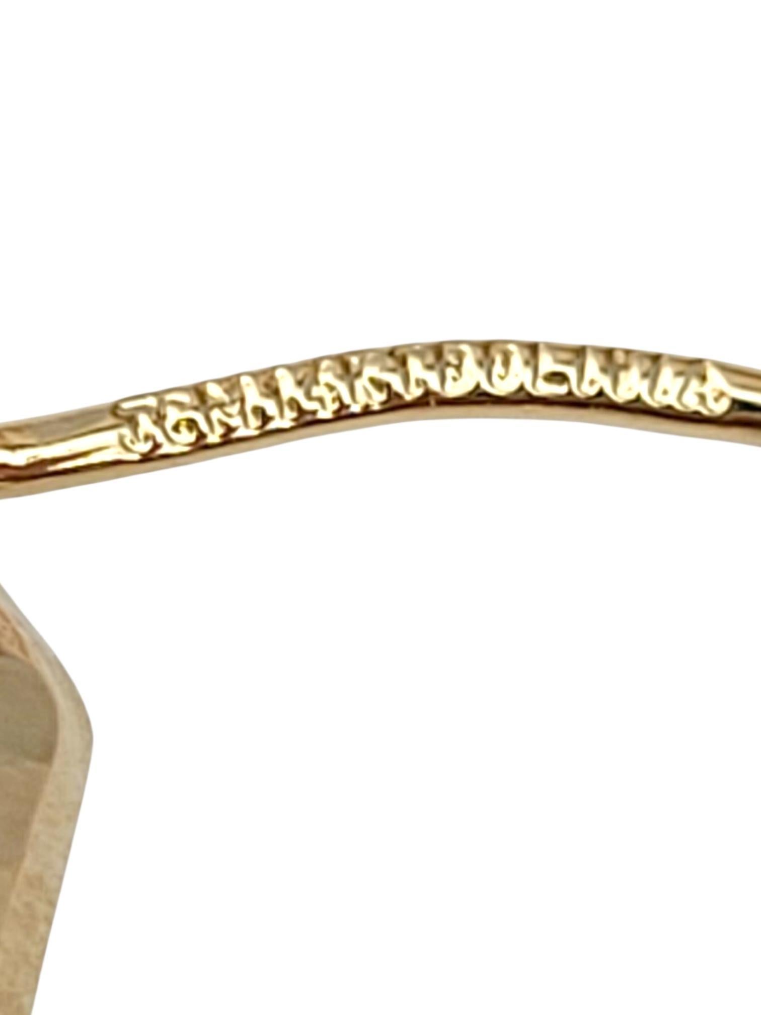 14K Yellow Gold Hammered Oval Hoop Earrings -

These hammered oval hoop earrings feature a unique textured finish that catches the light beautifully, adding depth and character to their elegant oval shape. Stylish and contemporary, they offer a