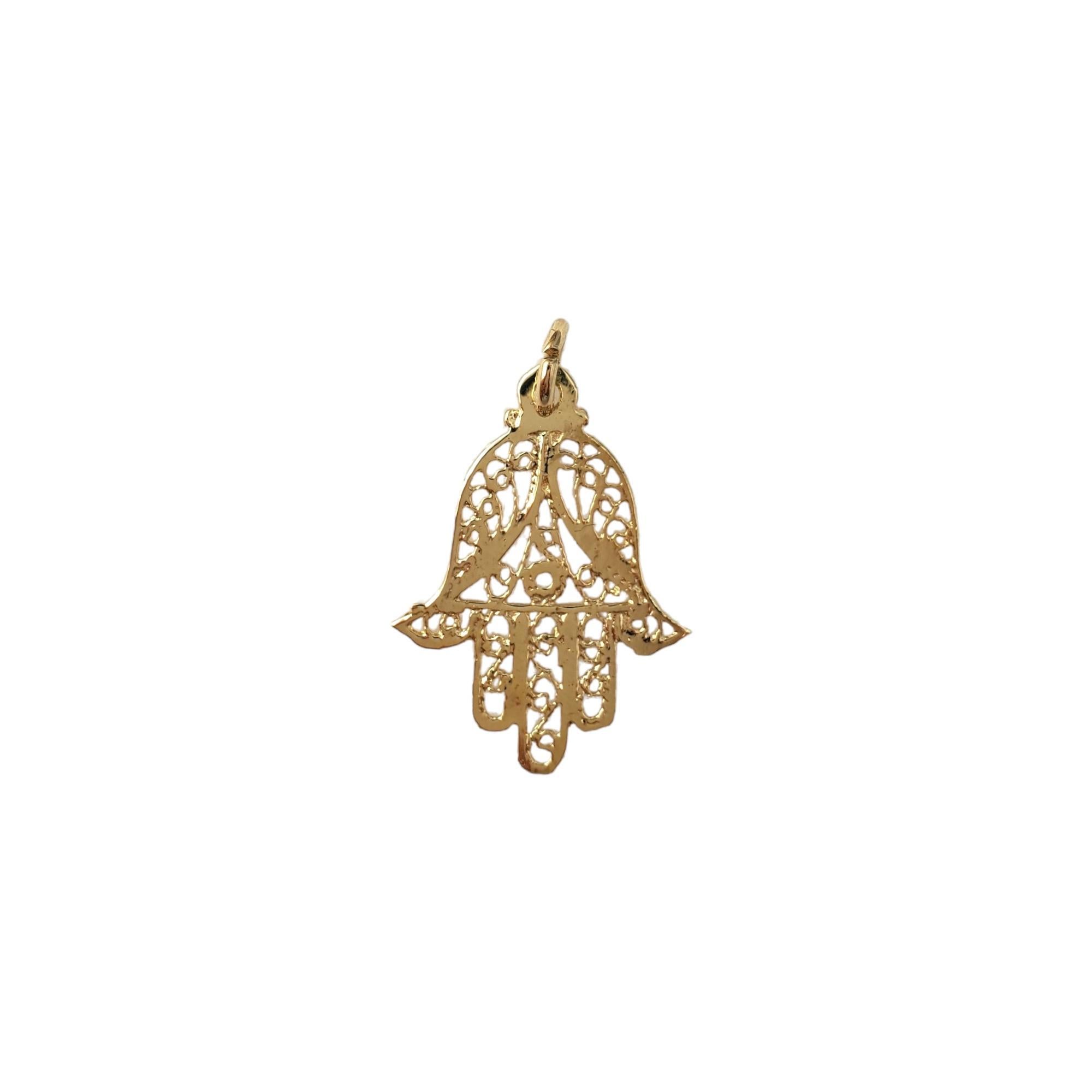 Vintage 14K Yellow Gold Hamsa Hand Charm - 

This Hamsa hand charm symbolizes good fortune and protection. 

Size:  25mm X 15mm

Weight:  0.3 dwt. /  0.47 gr.

Very good condition, professionally polished.

*Chain not included*

Will come packaged