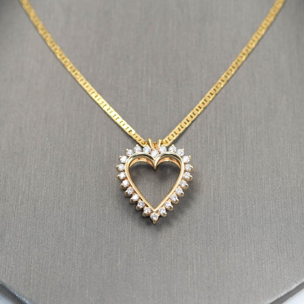 Ladies 14k yellow gold and diamond heart necklace.
Stamped 14k , Italy and weighs 9.8 grams.
The diamonds are round brilliant cuts, .75 total carat weight, G to H color, Vs to Si clarity.
The heart pendant measures 1 inch x 3/4 inch.
The chain is