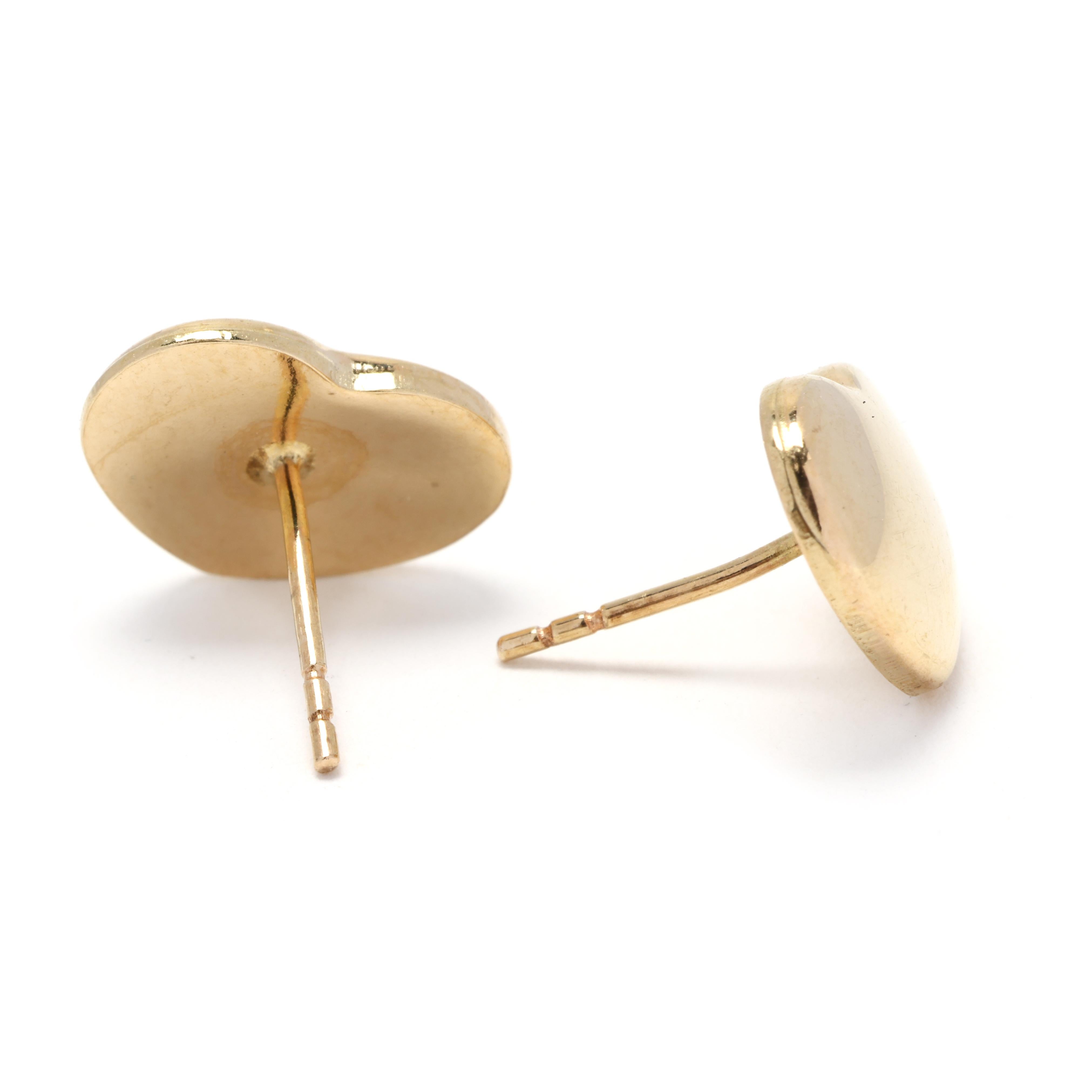 These 14k yellow gold heart earrings are both dainty and lovely. Crafted with high-quality gold, these earrings feature a delicate heart-shaped design that adds a touch of romance to any outfit. The earrings are lightweight and comfortable to wear,