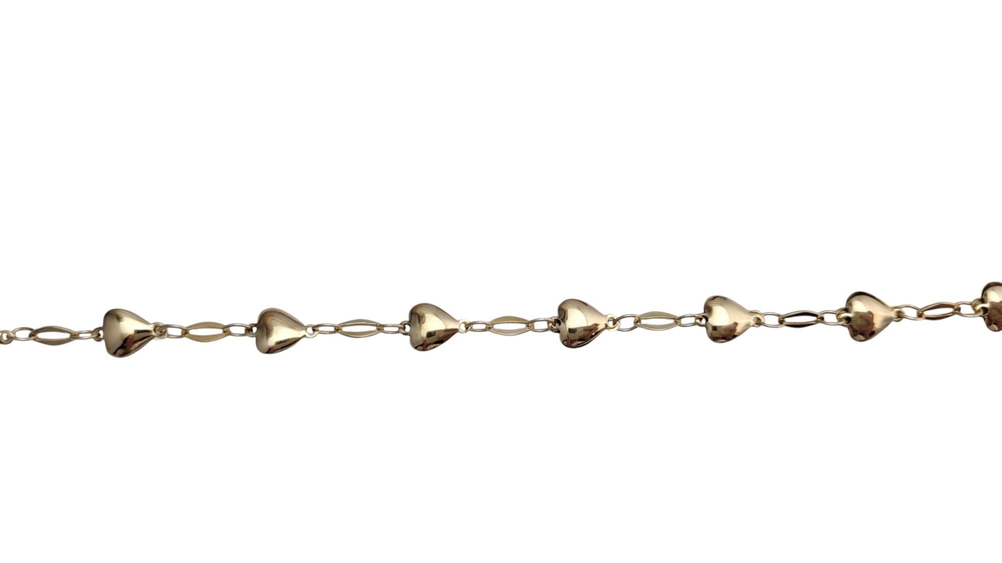14K Yellow Gold Heart Bracelet-

This delicate heart bracelet features a timeless design, symbolizing love and affection. Crafted with care and finished with a smooth, polished surface, it’s a versatile piece that adds a touch of elegance and warmth