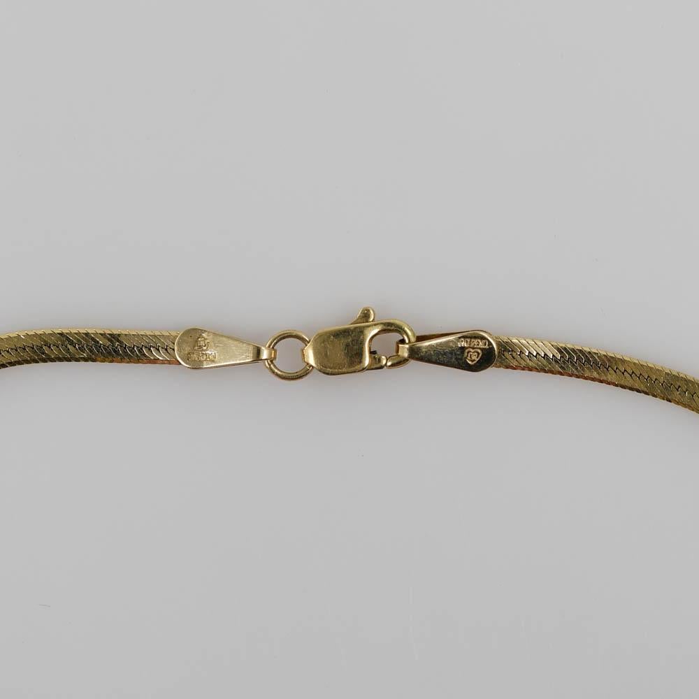14k yellow gold herringbone style bracelet.
The heart-shaped blue topaz measures 6mm by 6mm. 
Has two 0.01ct Old euro cut Diamonds on each side of the center stone.
Stamped and tested 14k.
Will fit up to 7-inch wrists.