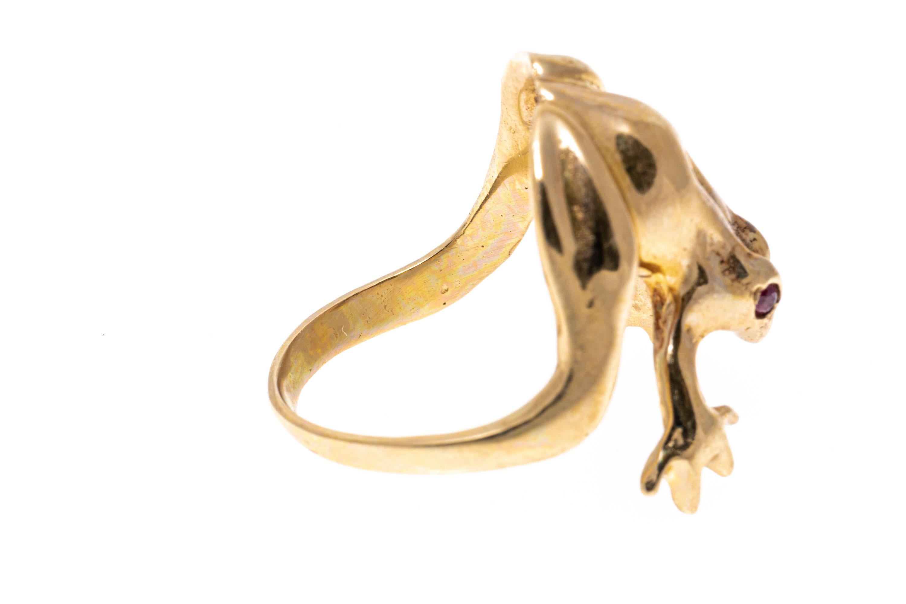 14k yellow gold ring. This charming ring is a frog motif, with a high polished finish, and decorated by round faceted ruby eyes, approximately 0.06 TCW.
Marks: 14k
Dimensions: 5/8