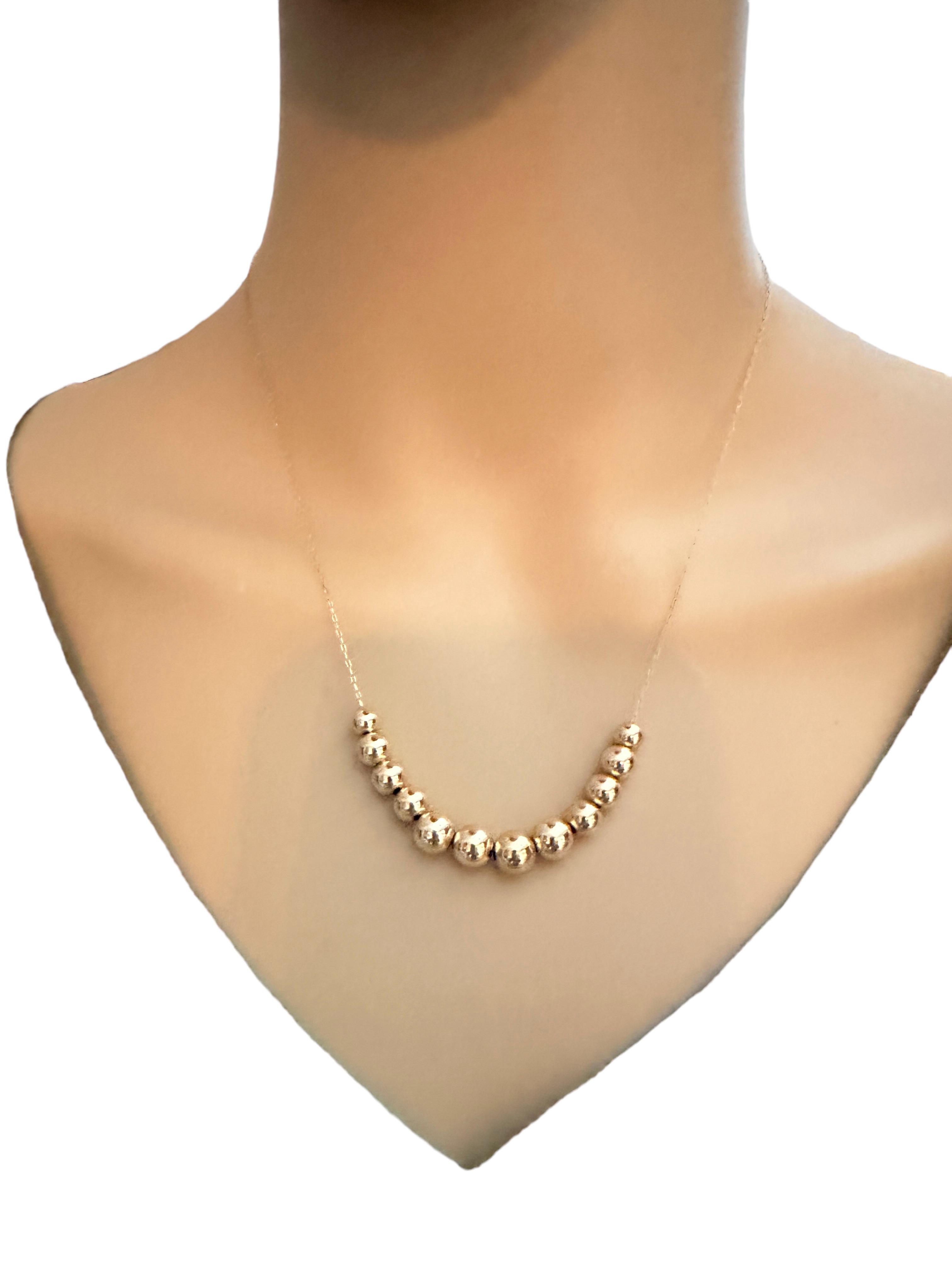 This is a gorgeous and delicate necklace!  It is pre-owned but in fabulous condition.  The chain is 14k Yellow Gold and is 18 inches long.  It has 12 14k Gold beads, the largest is 7mm and graduates down to the smallest which is 5 mm.  It has a
