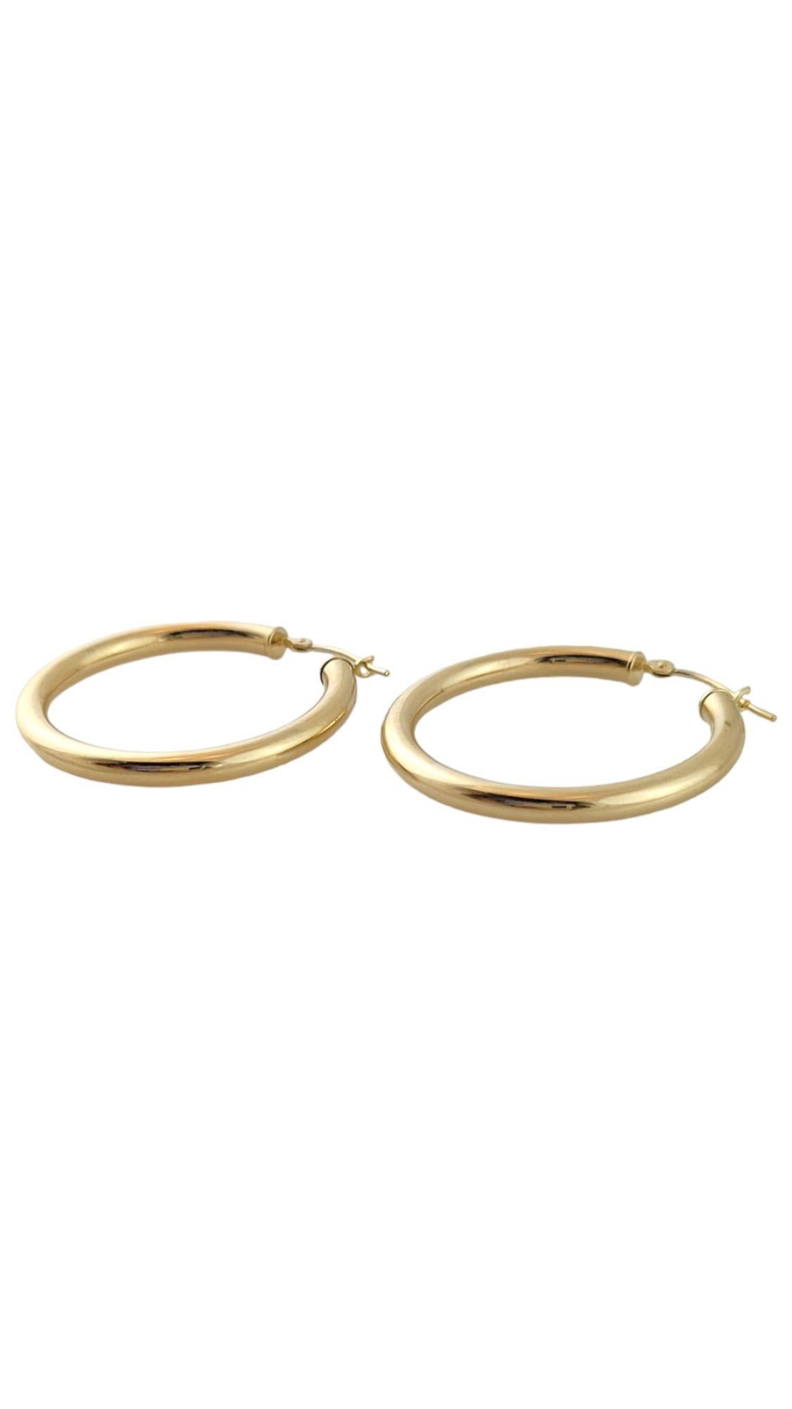 This classic set of 14K gold hoops are simple yet beautiful!

Size: 31.2mm X 30.2mm X 3mm

Weight: 2.1 g/ 1.4 dwt

Hallmark: 14K MB

Very good condition, professionally polished.

Will come packaged in a gift box or pouch (when possible) and will be