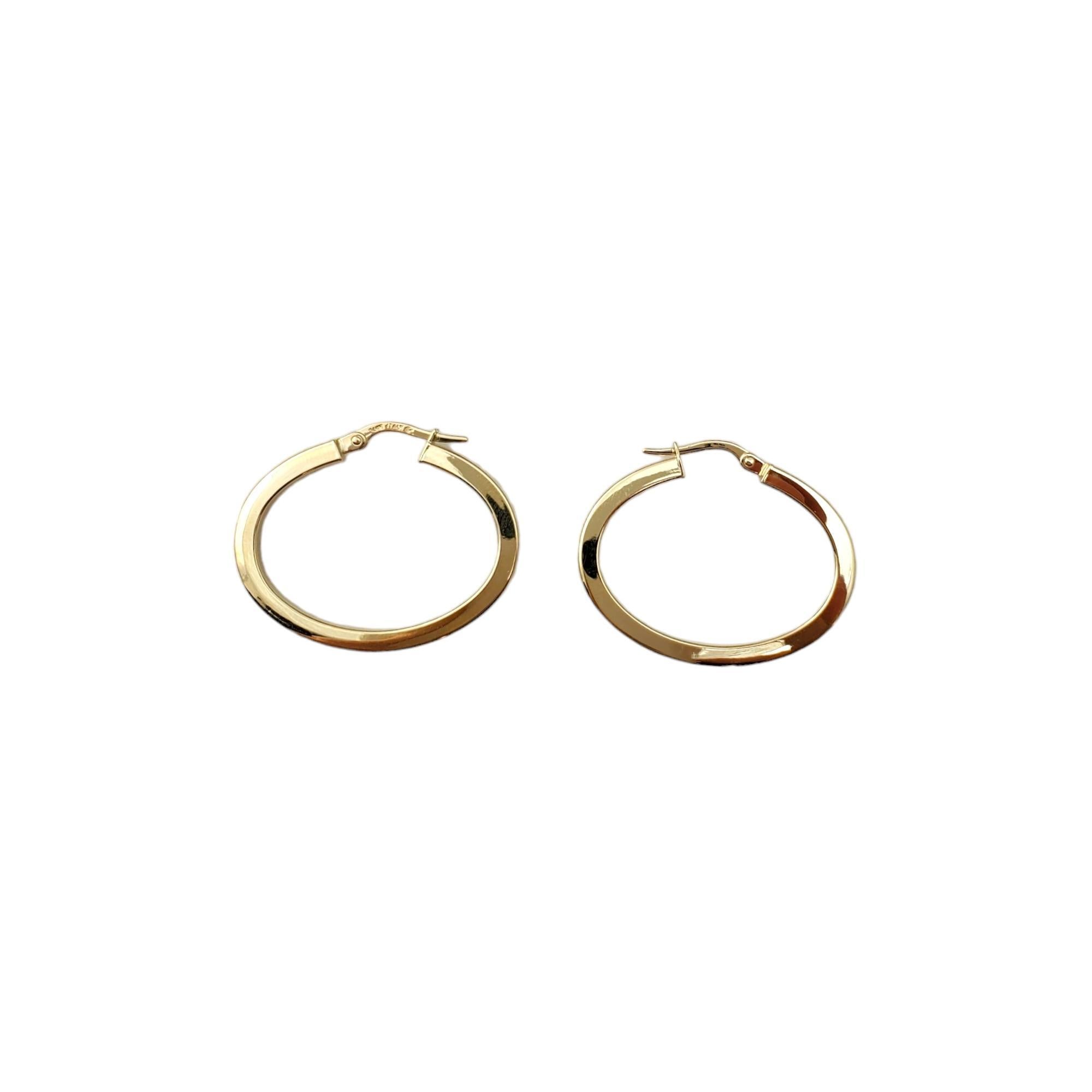 14K Yellow Gold Hoop Earrings -

These simple hoop earrings are a classic accessory. 

Size:  30.0 mm X 2.6 mm X 2.8mm 

Hang a little over an inch in length. Approx. 3mm wide

Weight:  1.2 dwt. /  2.0 gr.

Marked: 14K Italy

Very good condition,