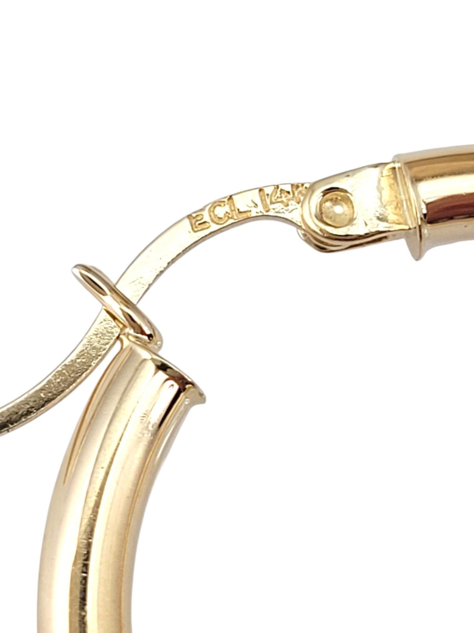 14K Yellow Gold Hoop Earrings -

These hoop earrings offer a timeless, elegant design that effortlessly complements any outfit. With their smooth, polished finish and versatile style, they’re perfect for adding a subtle touch of sophistication to
