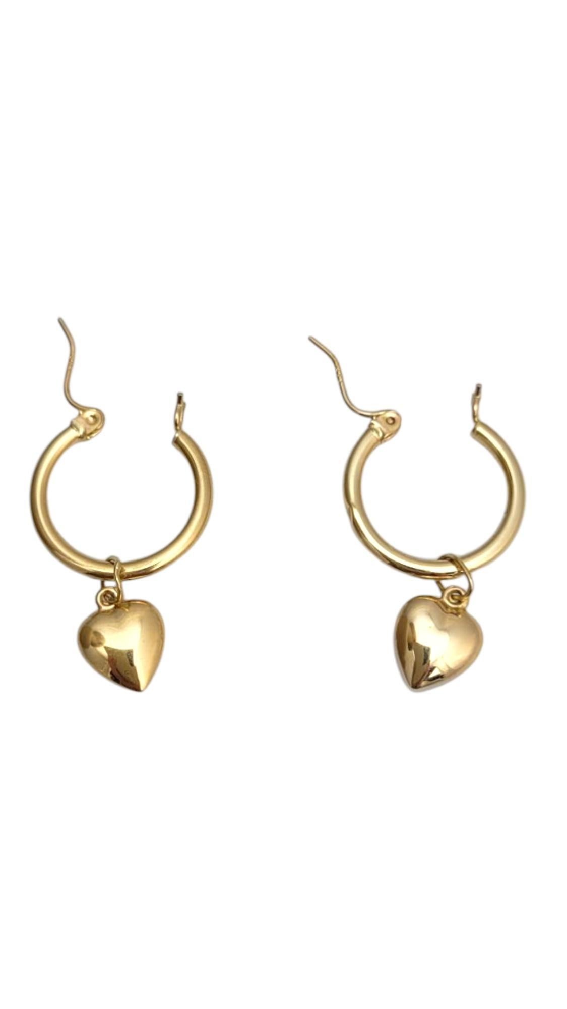 14K Yellow Gold Hoops with Heart Dangle Earrings-

Add a touch of love to your look with these charming heart dangle earrings. Crafted in gleaming 14k yellow gold, they feature delicate heart-shaped accents that sway gracefully with every movement.