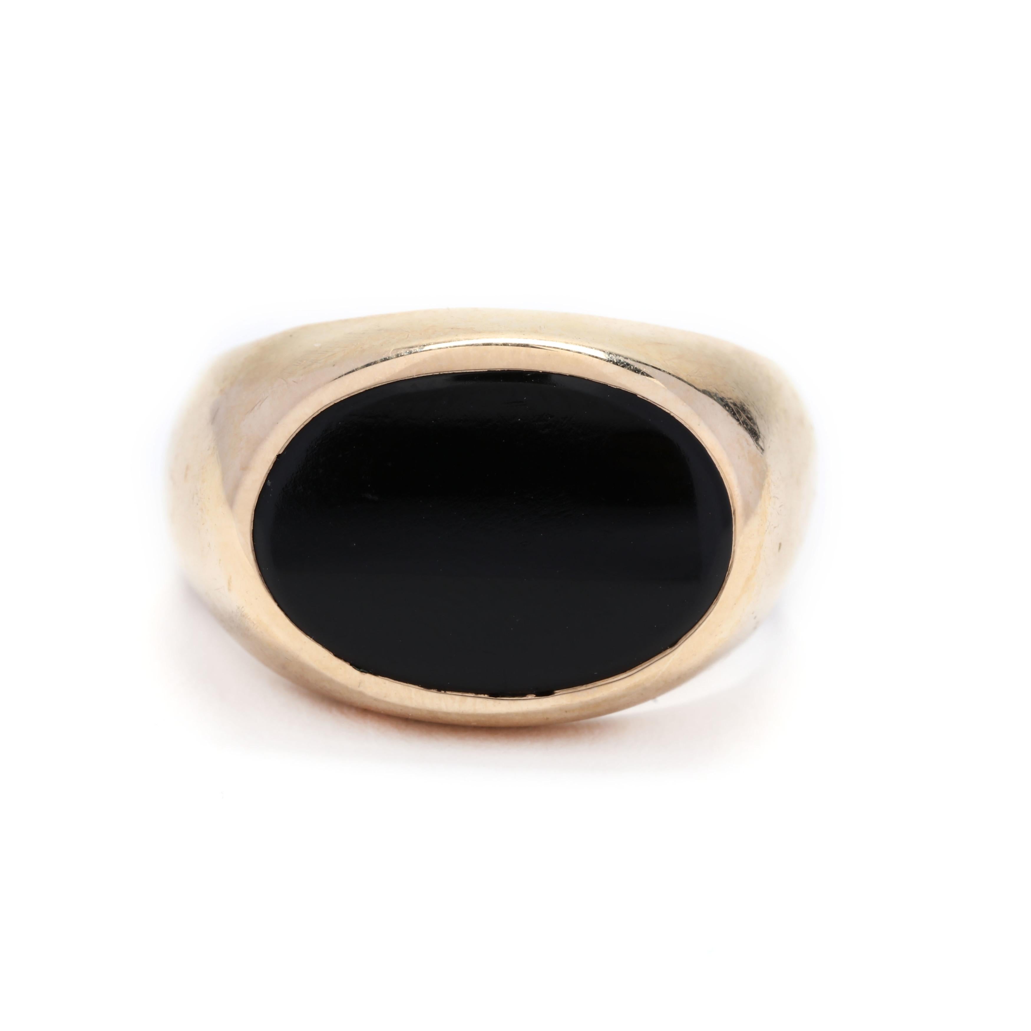 A vintage 14 karat yellow gold and black onyx horizontal signet ring. This ring features an oval tablet cut black onyx, bezel set in a horizontal fashion and with a tapered shank.



Ring Size 5.5



Width: 12.4 mm



Weight: 3.72 dwts.