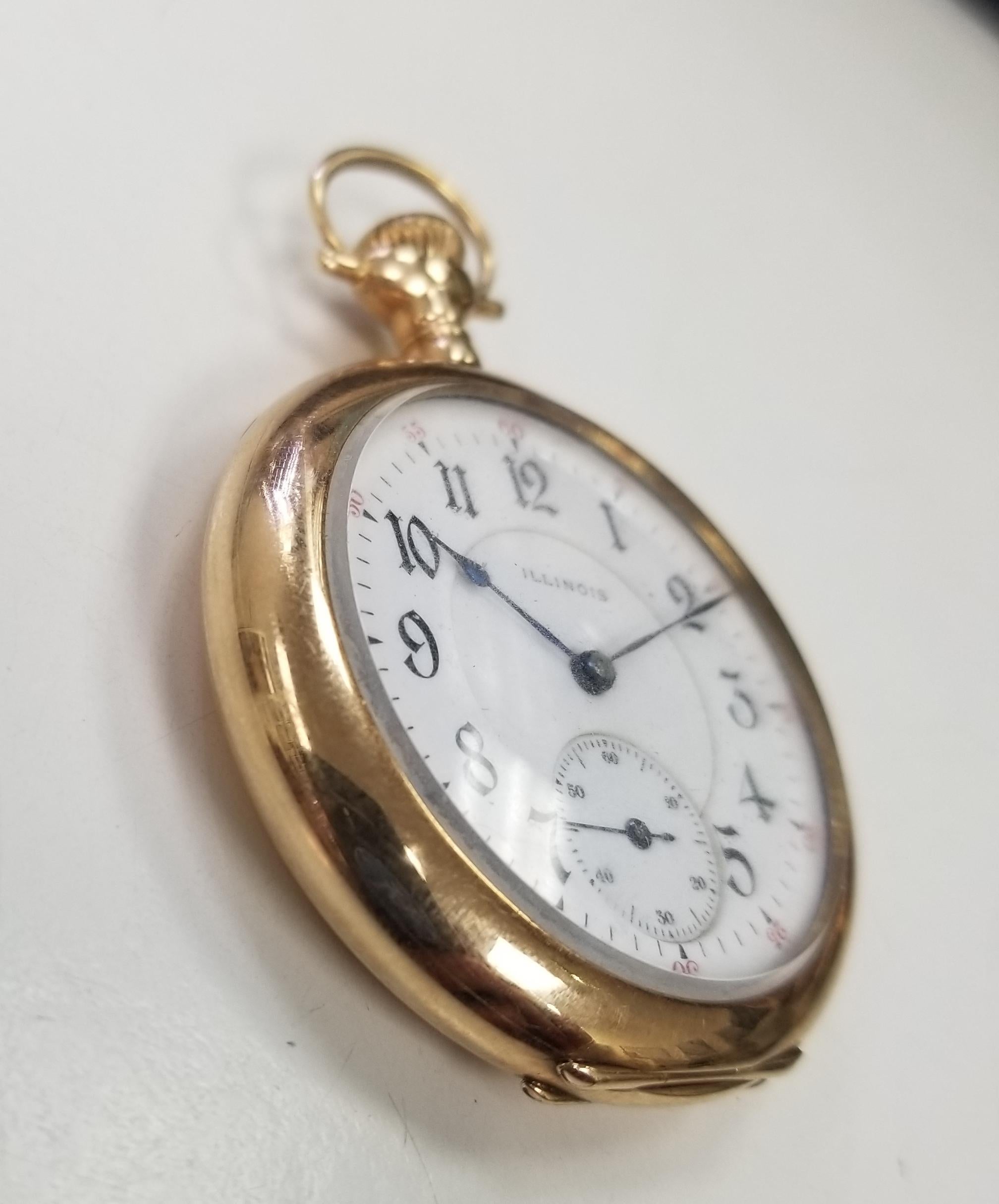 Absolutely beautiful pocket watch.  Made by Illinois 1900s.  Heavy gauge 14K yellow gold.  In pristine crisp condition with hand engraving on the back. 17 jewels.  Manual wind.  White enamel dial with black enamel  numerals.  38mm in diameter. 