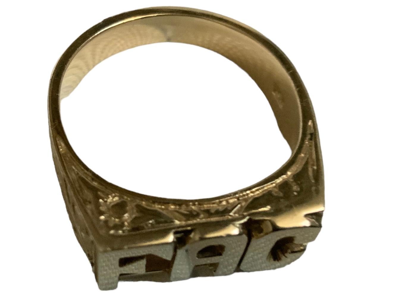This is a 14K Yellow Gold Initials/Monogram Ring. It depicts a gold ring with the letters- F, A and C arranged horizontally at the top of the ring. The shanks are adorned with engraved S-shaped scrolls. The ring is hallmarked 14K below the shank.