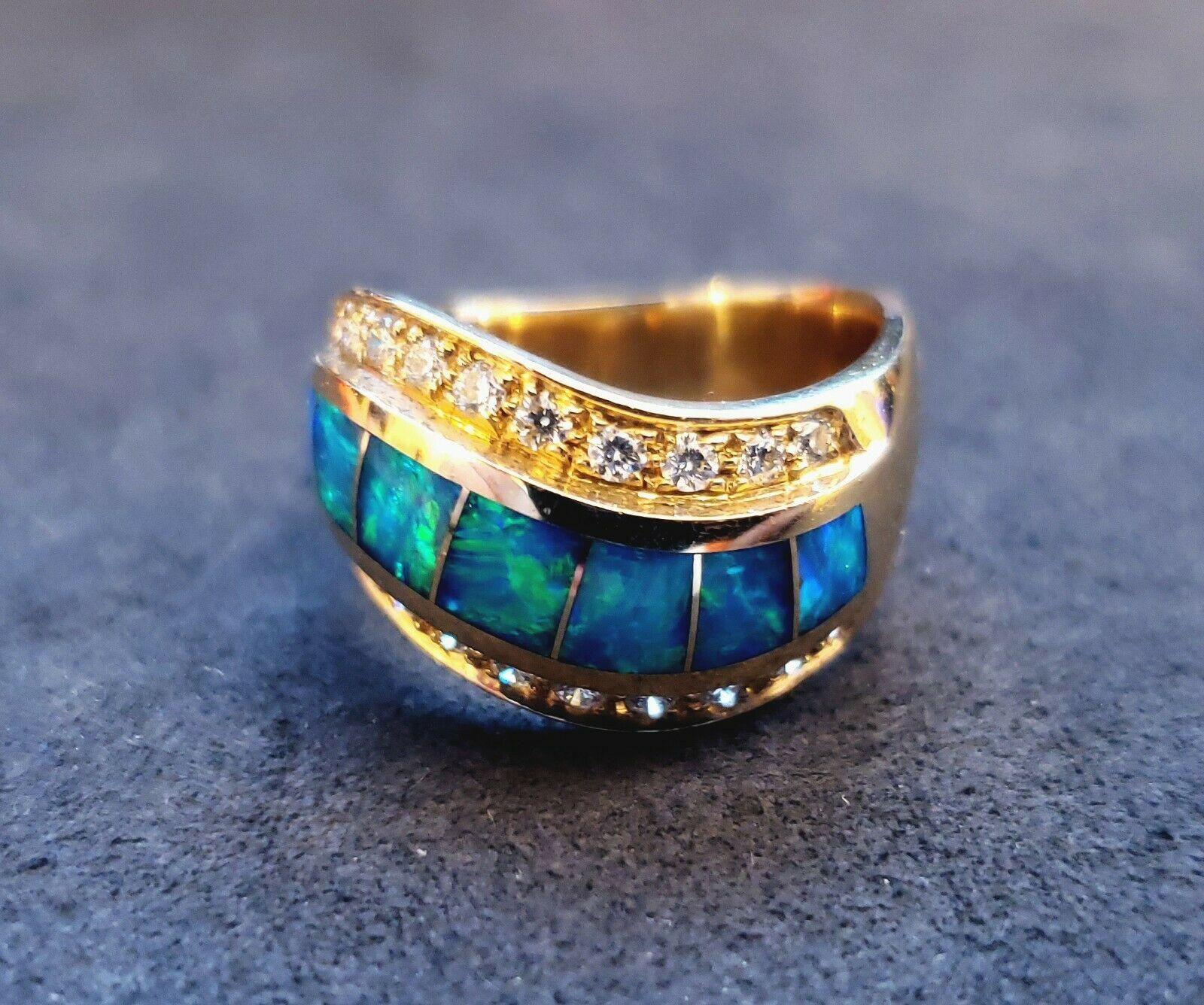 Amazing craftsmanship on this 14k yellow gold inlaid dublet opal ring. It consists of 7 square opals lined on both side with round diamonds that are approximately 0.50 carat total weight, G in color, and SI1 in clarity. 
Specifications:
    main