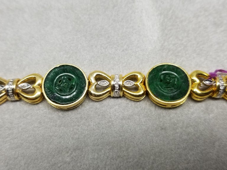 This piece of fine jewelry was designed and hand crafted by “Moshi” of New York, it was found in a vault from an estate sale and was never used.  14k yellow gold jade and diamond bracelet with 42 diamonds and 6 button jades pieces.