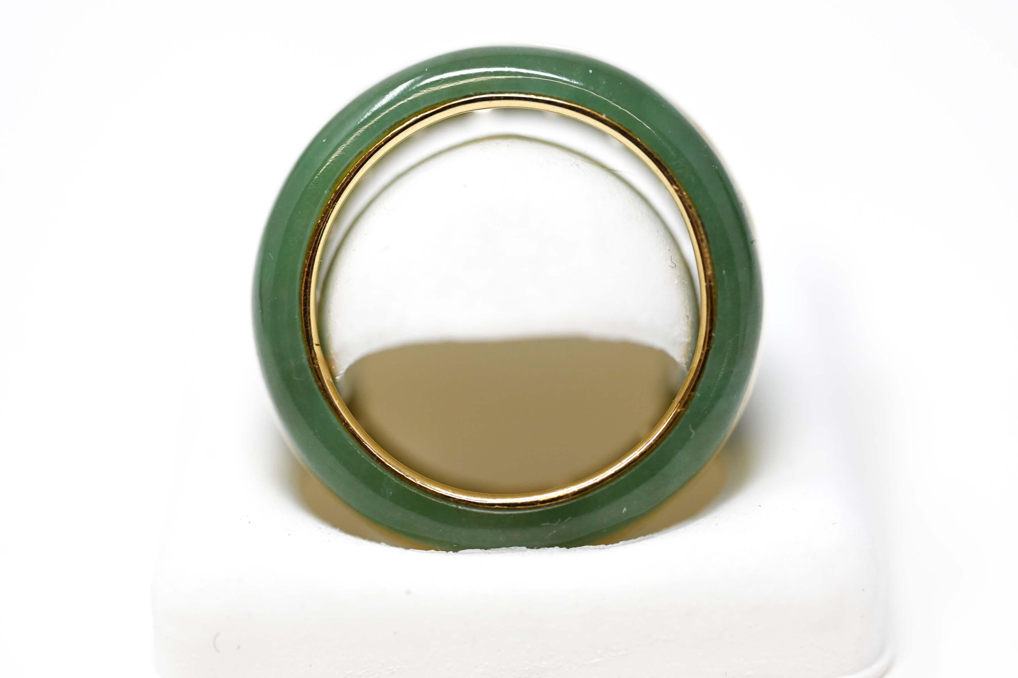 Vintage 14k yellow gold ring size 8. Made of jade and peridot gemstones. Stamped 14k and maker mark inside. The ring cannot resized.
