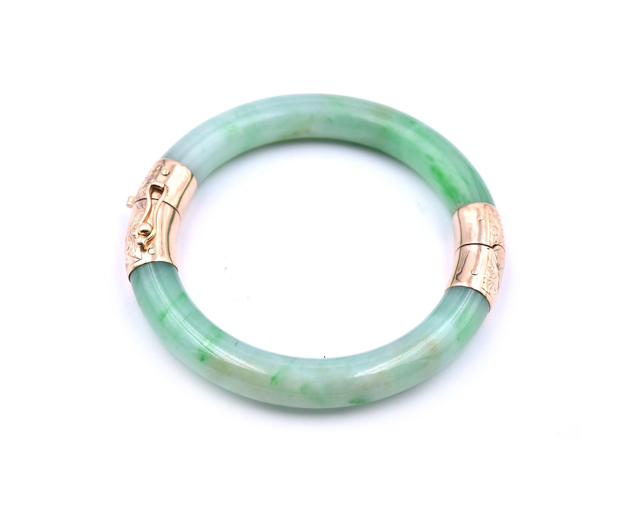 Designer: custom design
Material: 14k yellow gold 
Gemstones: jade
Dimensions: bracelet will fit a 6-inch wrist, it is 8.45mm wide
Weight: 37.08grams
