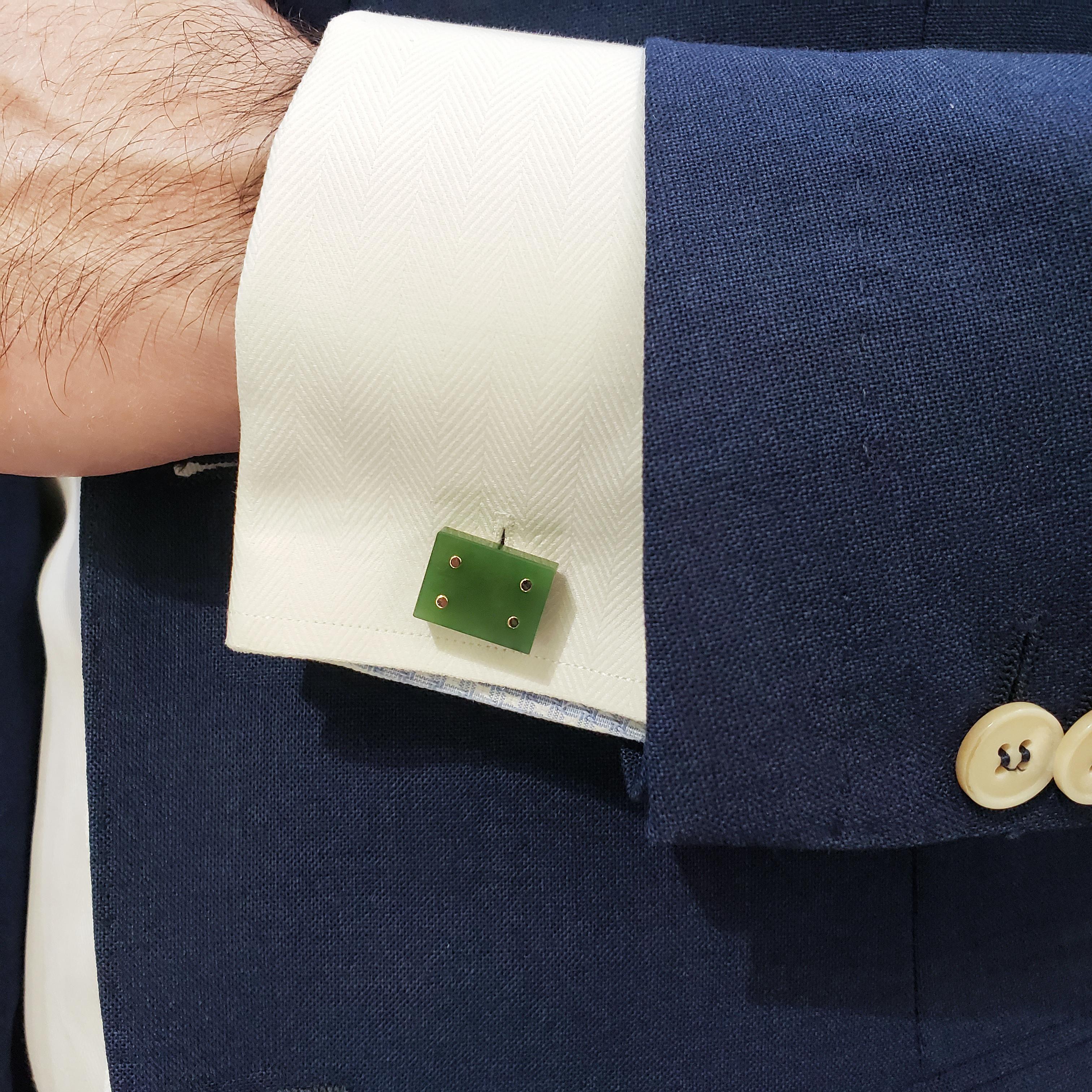 A unique  pair of domino-designed cufflinks showcasing square jades, each finished with four gold buttons. Set in 14K Yellow Gold with whale backs. 

