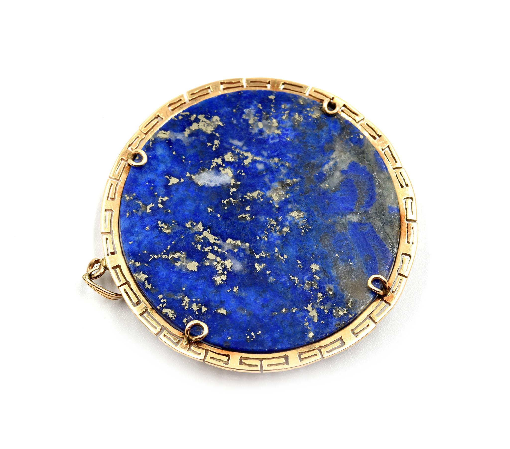 Designer: custom design
Material: 14k yellow gold, black onyx and lapis lazuli
Dimensions: pendant measures 2 inches in diameter
Weight: 17.50 grams
